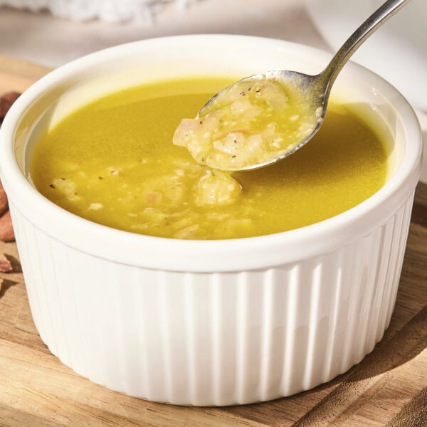 Small bowl with lemon Parmesan vinaigrette dressing.