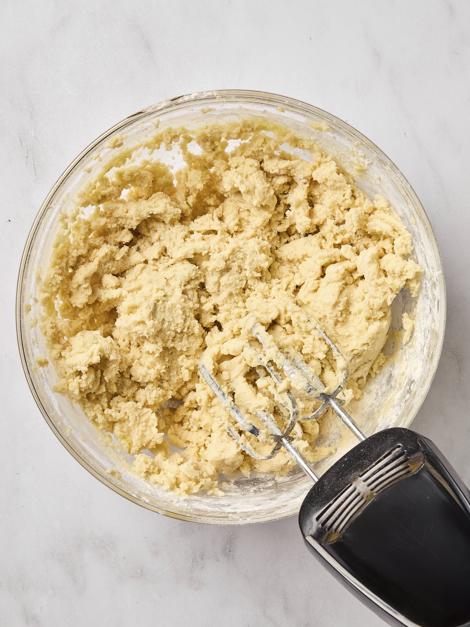 Dough for sugar cookies in glass bowl.