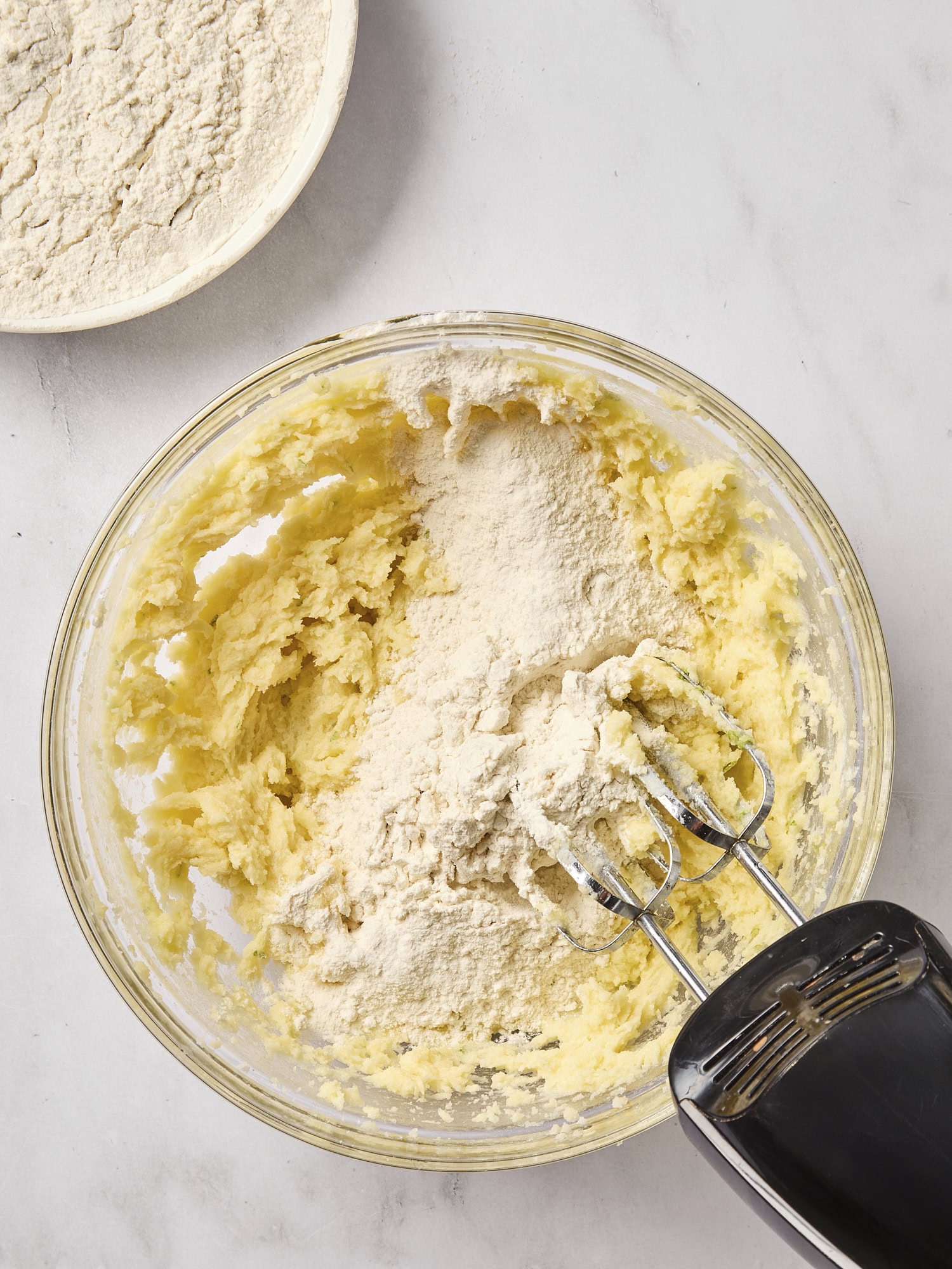 Flour being added to dough for lime sugar cookies.