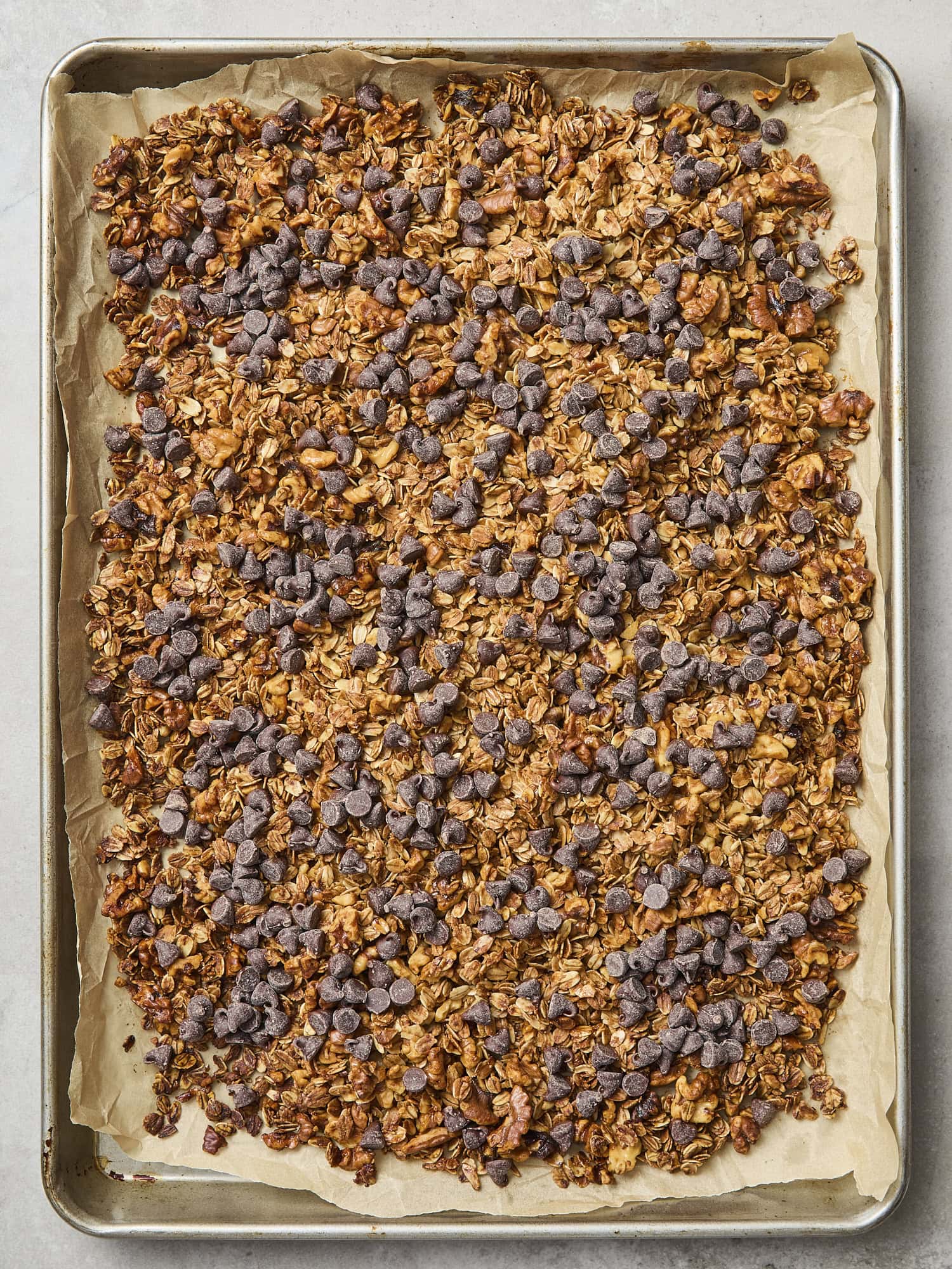 Chocolate chips sprinkled on top of baked granola.