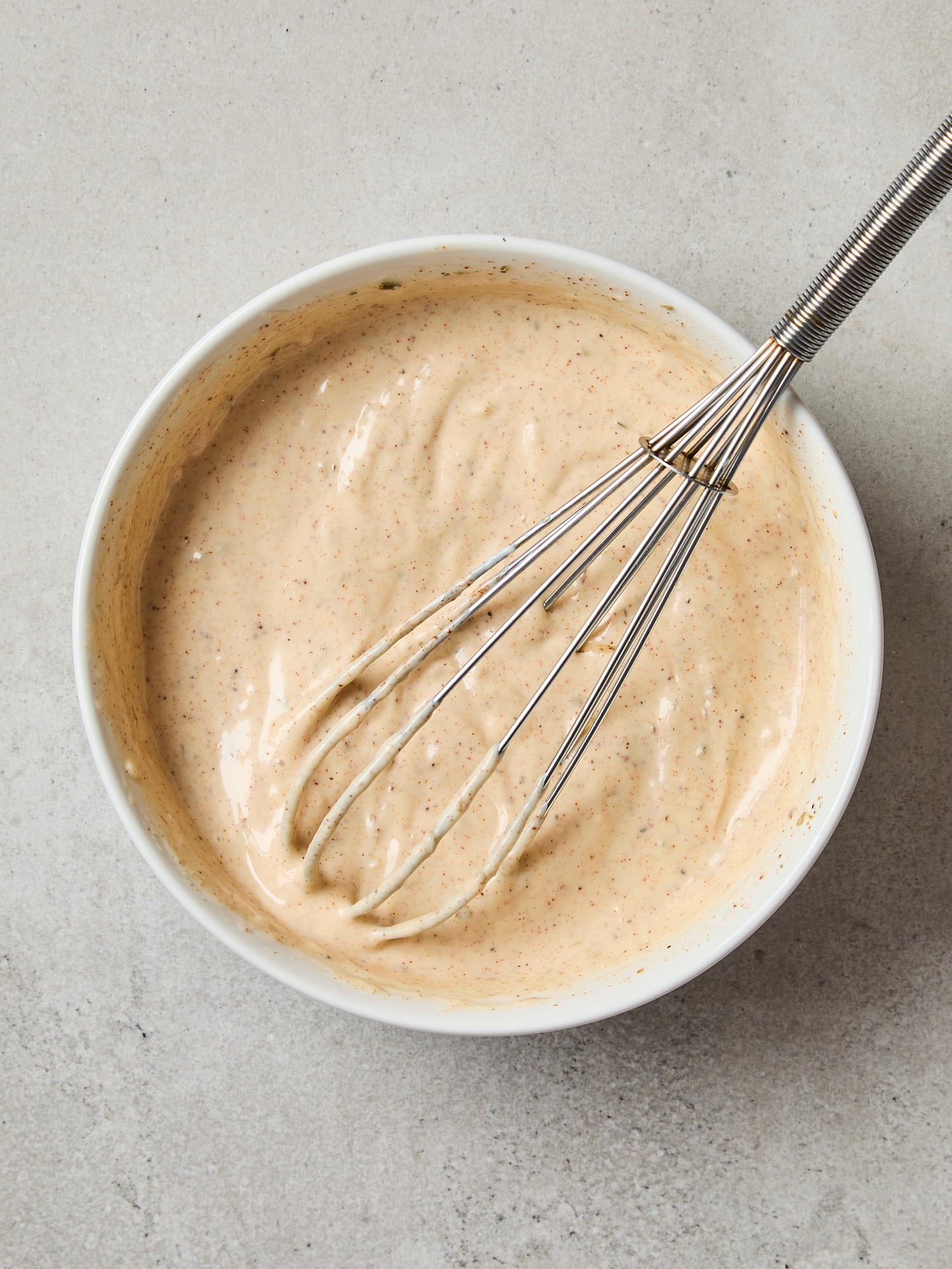 All ingredients for chipotle mayo whisked together in a bowl.