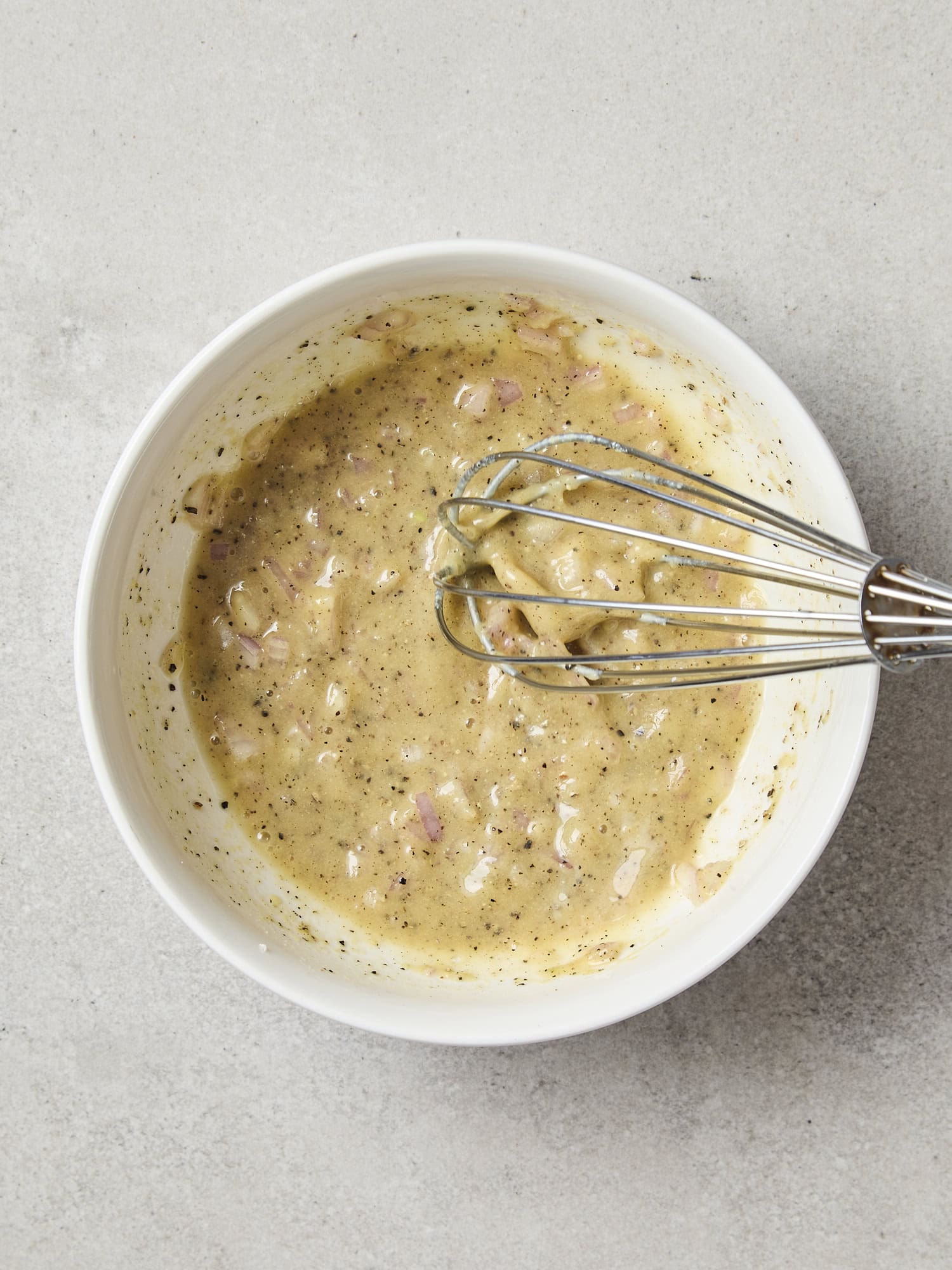 Ingredients mixing together for a creamy vinaigrette.