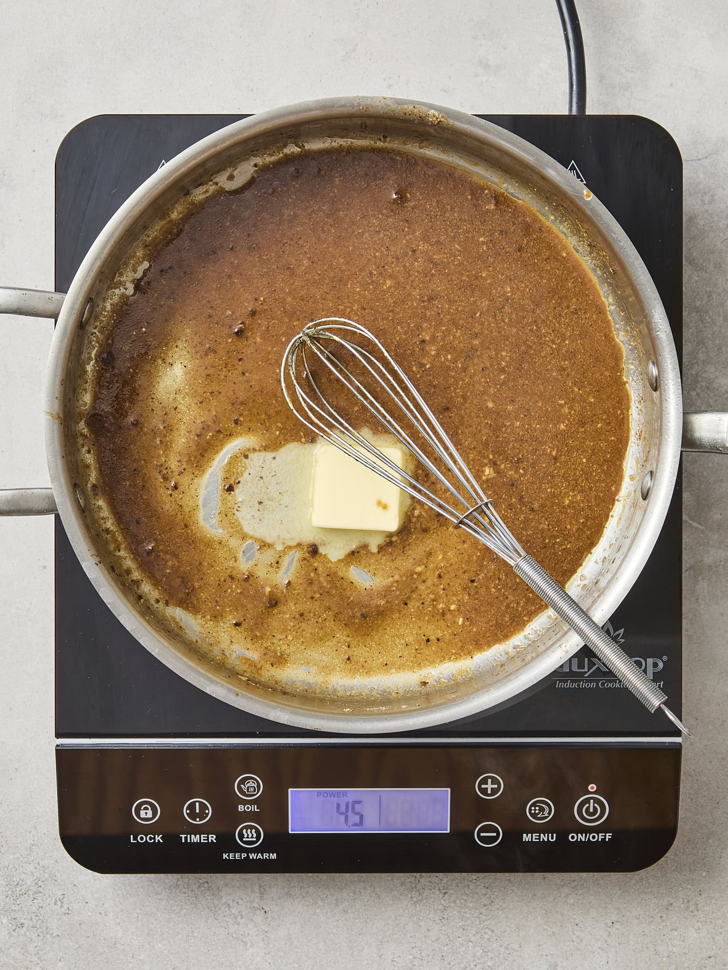 Skillet with pan sauce with butter melting.