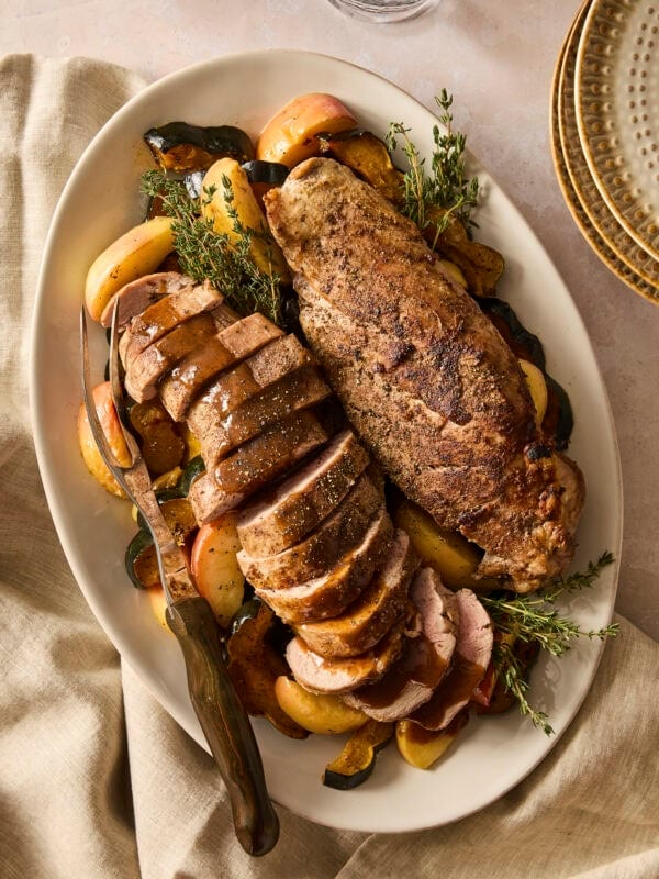 Sliced pork tenderloin with apples and roasted squash drizzled with pan sauce.