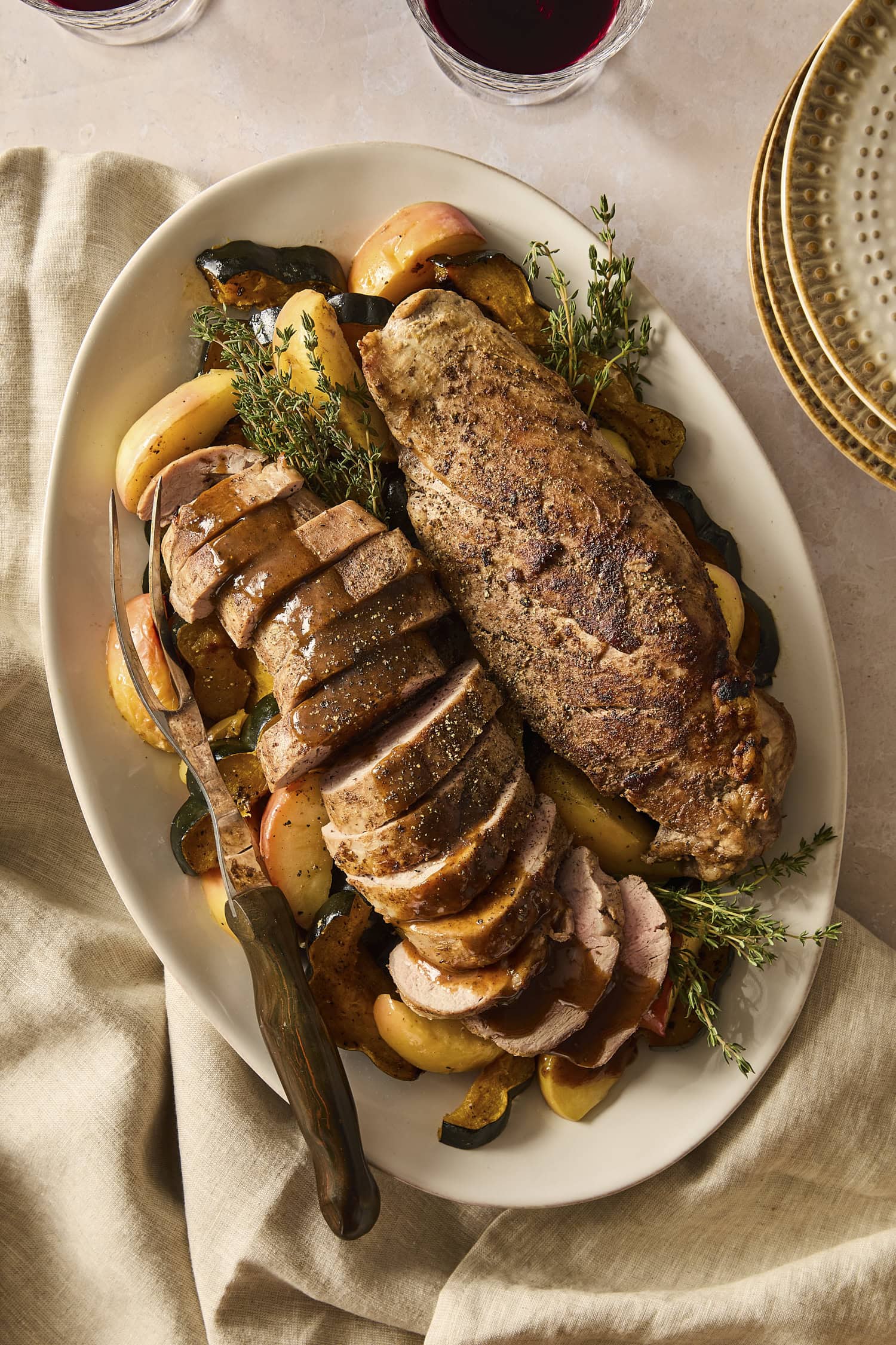 Sliced pork tenderloin with apples and roasted squash drizzled with pan sauce.