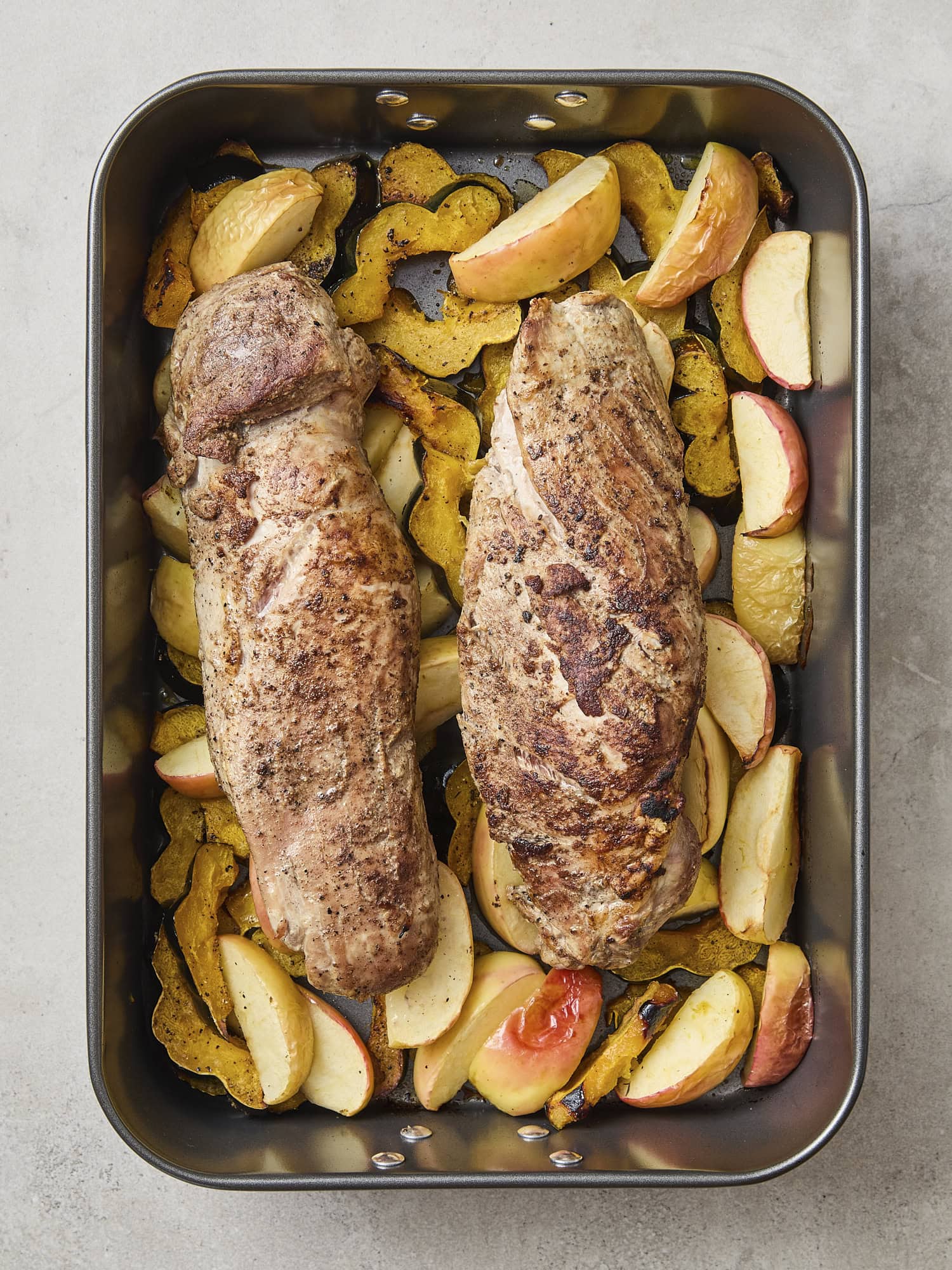 Pork tenderloin with apples and squash after roasting.