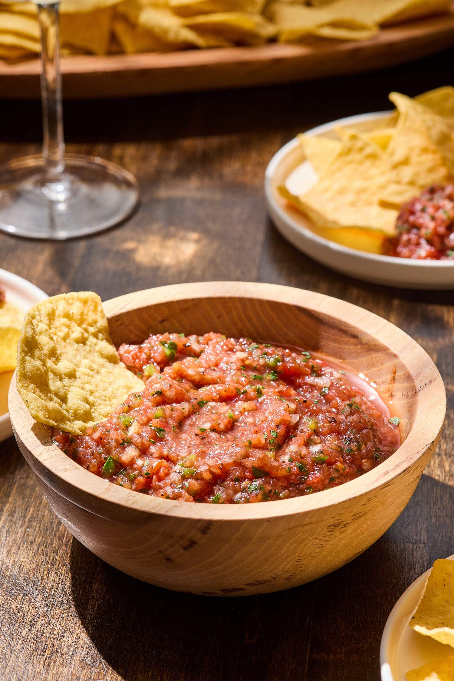 Tortilla chip dipping into restaurant-style salsa.