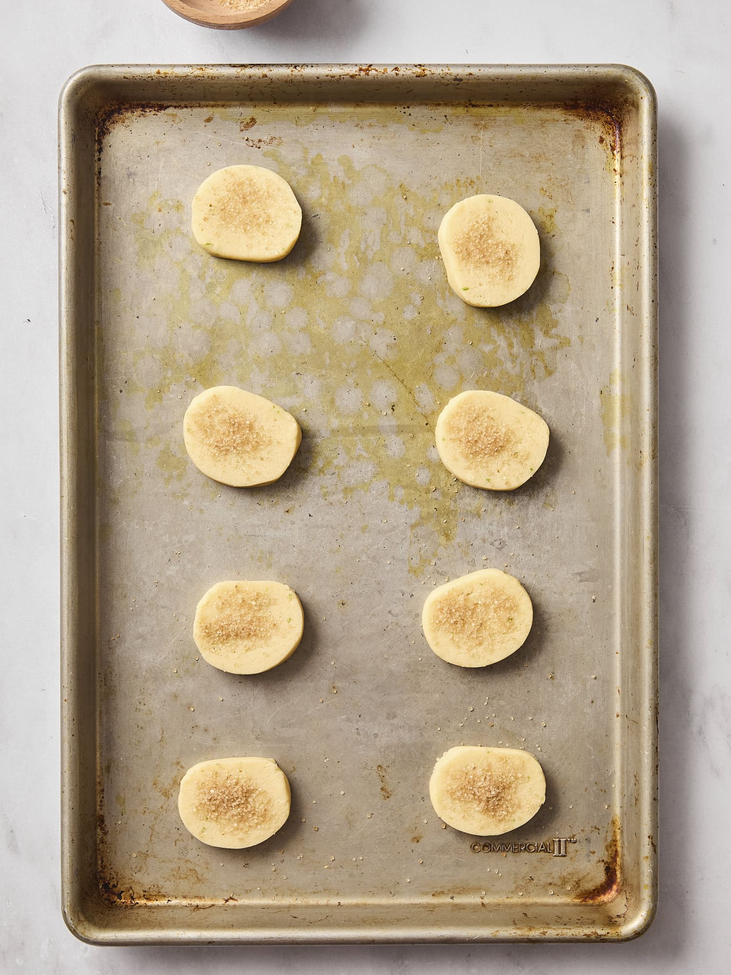 Unbaked sliced lime sugar cookies.