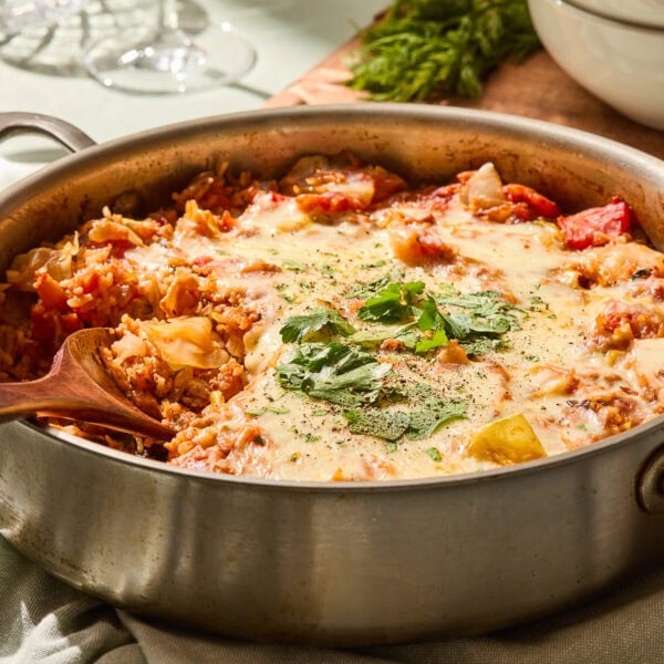 Unstuffed cabbage skillet in a pan with a scoop taken out.