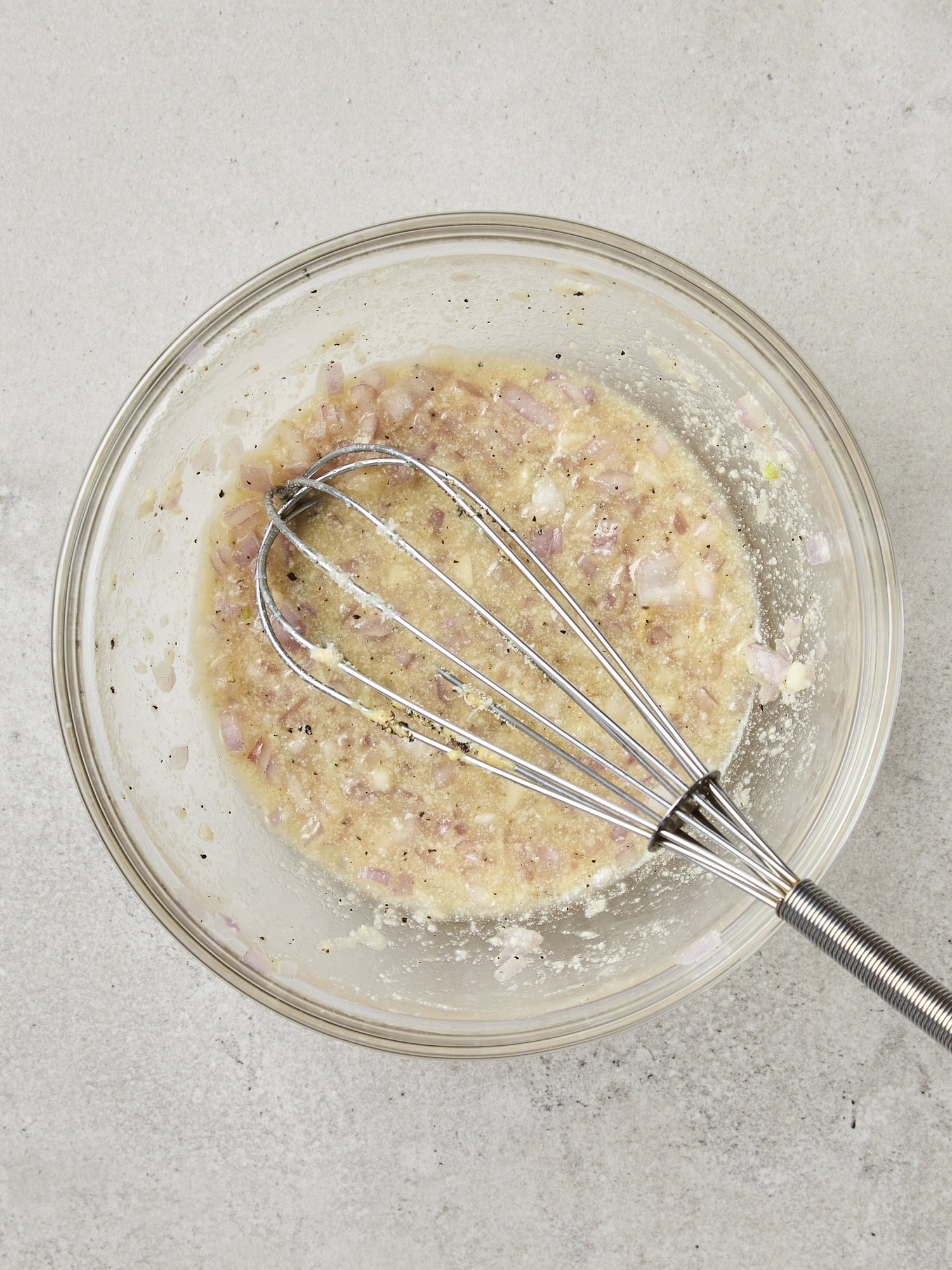 Bowl with ingredients before mixing for vinaigrette.
