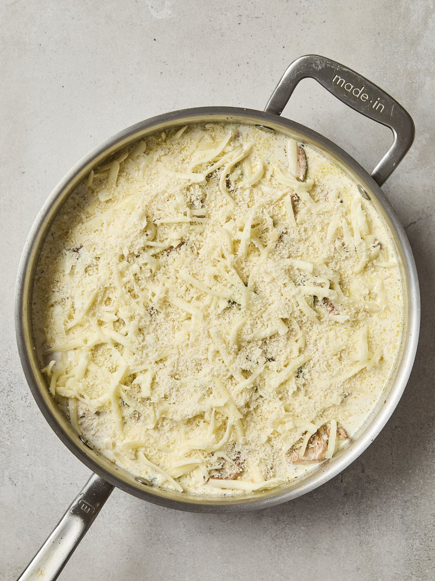 Cheese sprinkled on top of casserole ready for the oven.