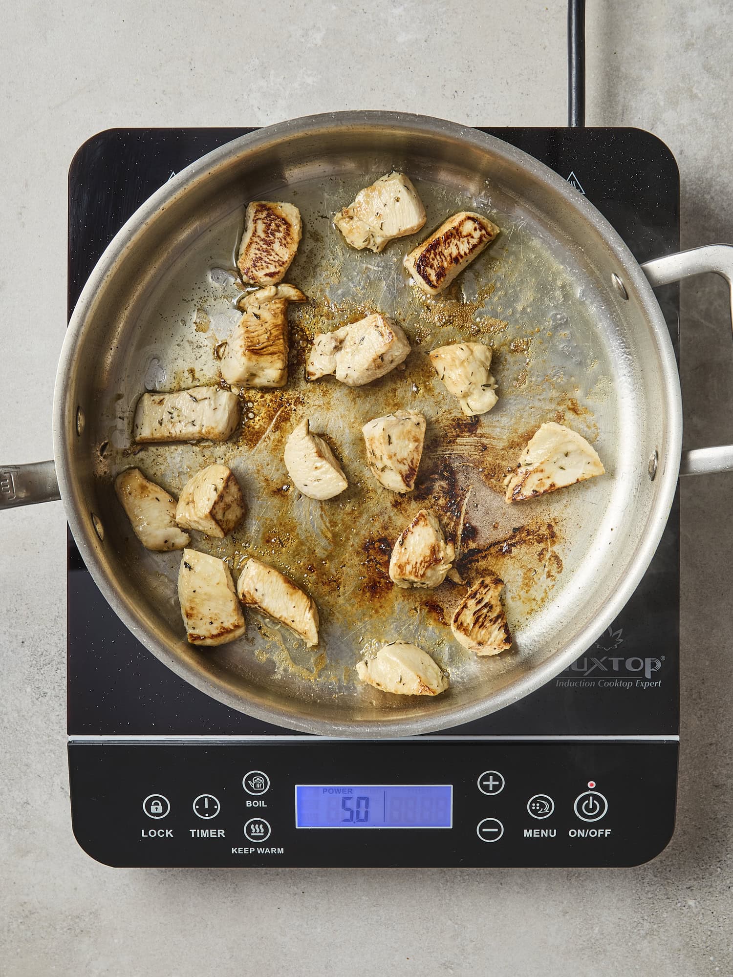 Browned chicken in pan for casserole.