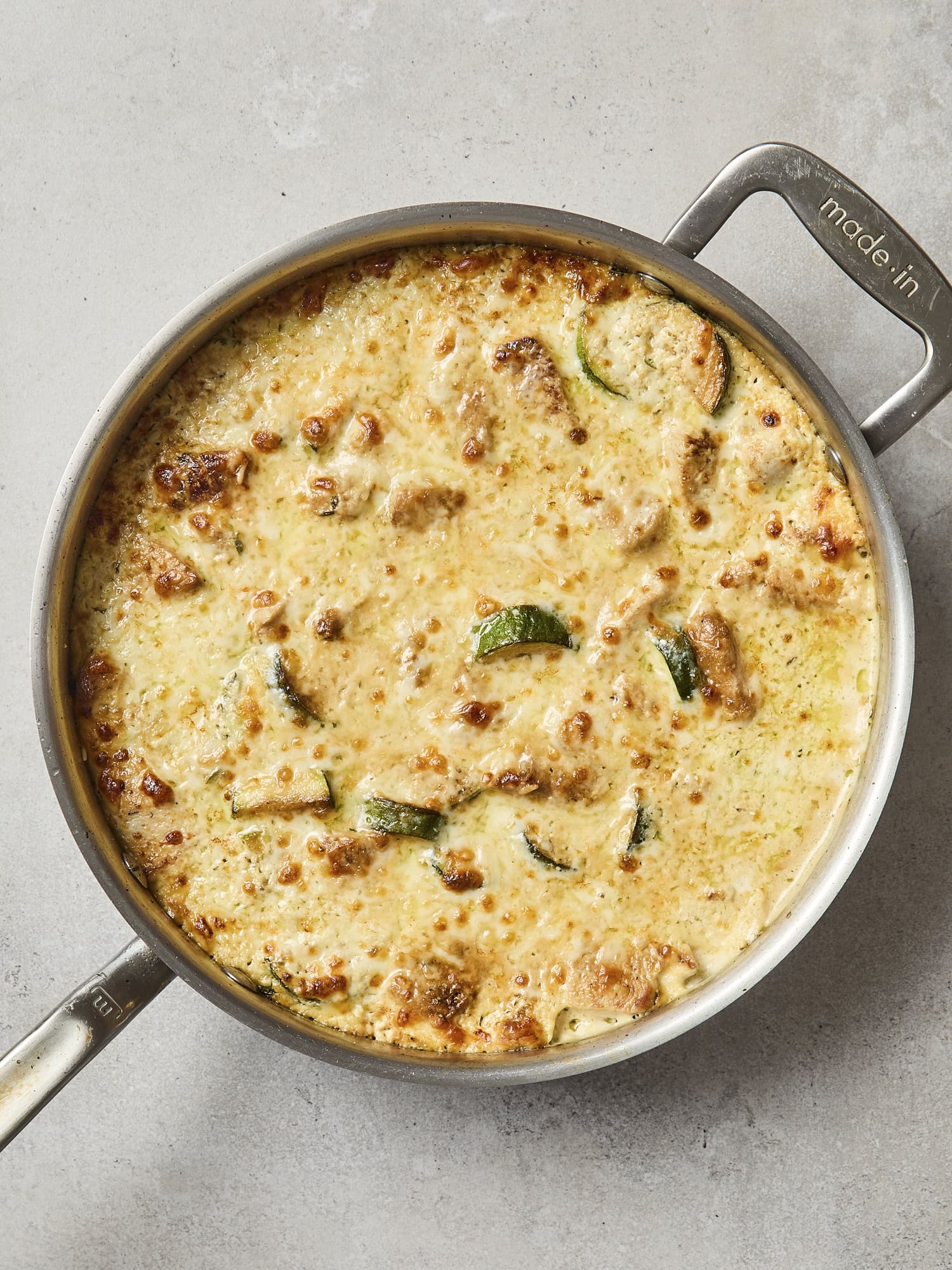 Golden brown baked chicken zucchini rice casserole.