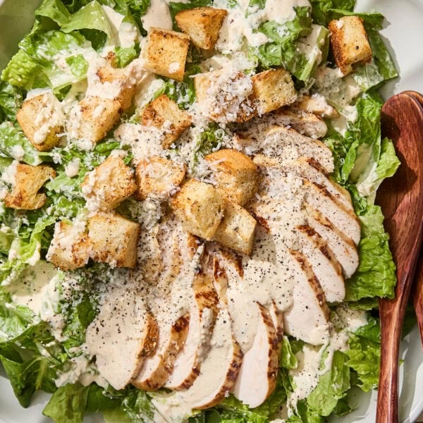 Chicken Caesar salad with sliced chicken, croutons, and dressing.