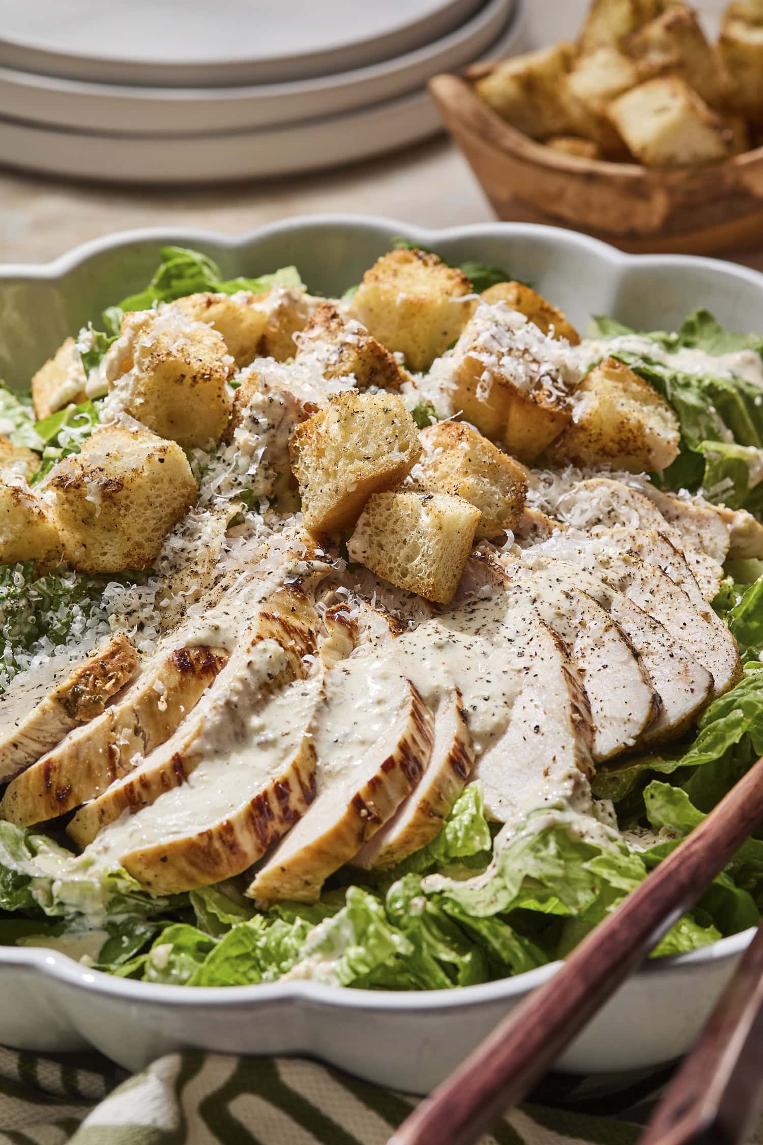Sliced chicken and croutons for a homemade chicken Caesar salad.