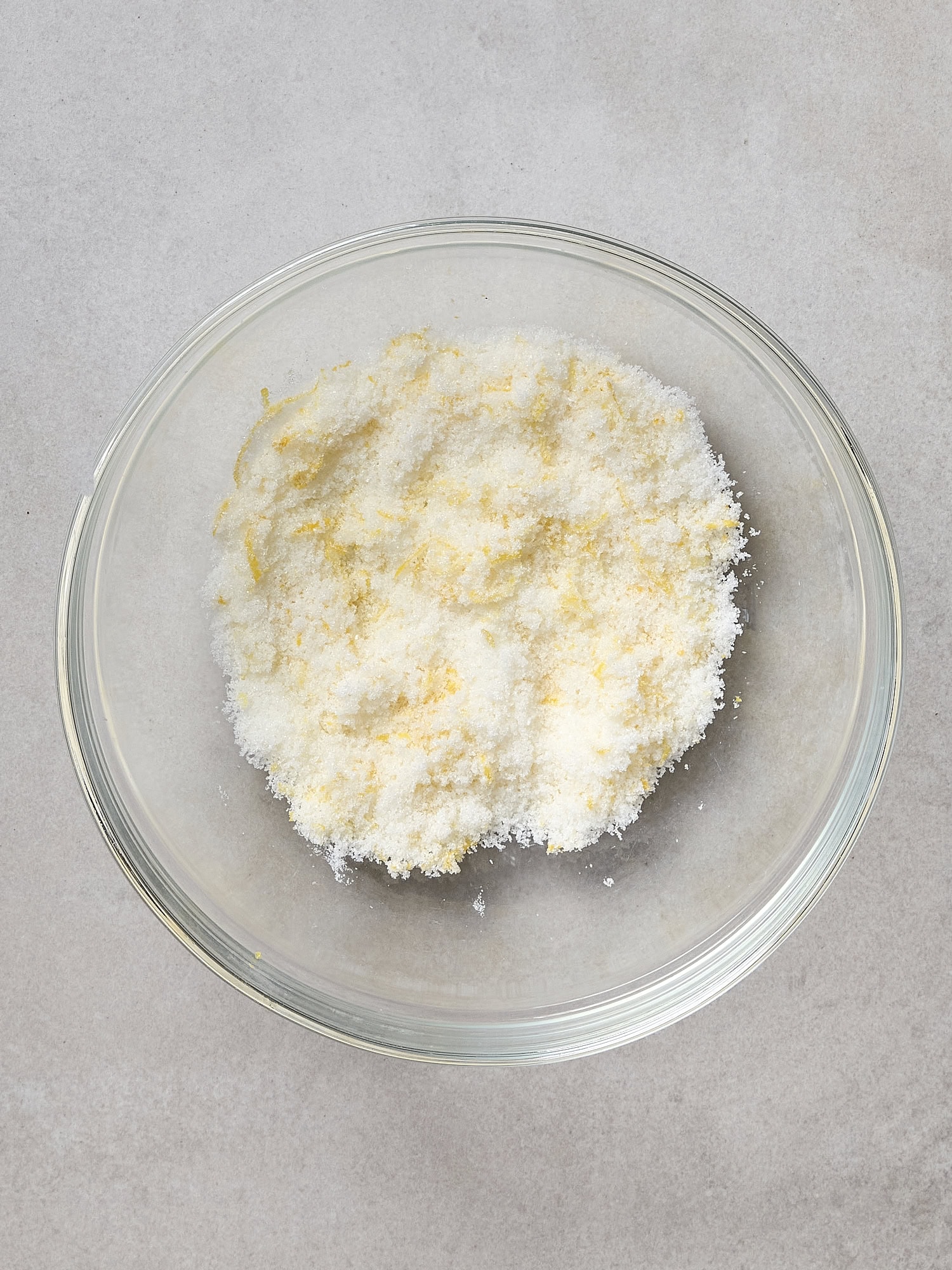 Lemon zest and sugar mixed together in bowl.