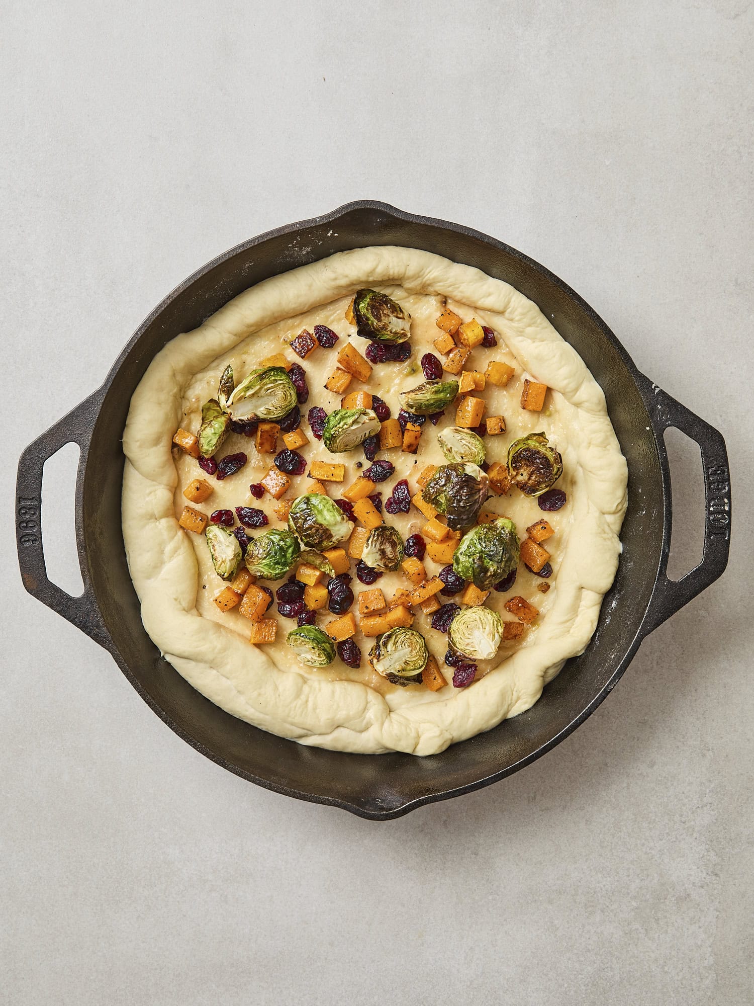 Pizza dough with garlic brown butter sauce and roasted butternut squash and Brussels sprouts.