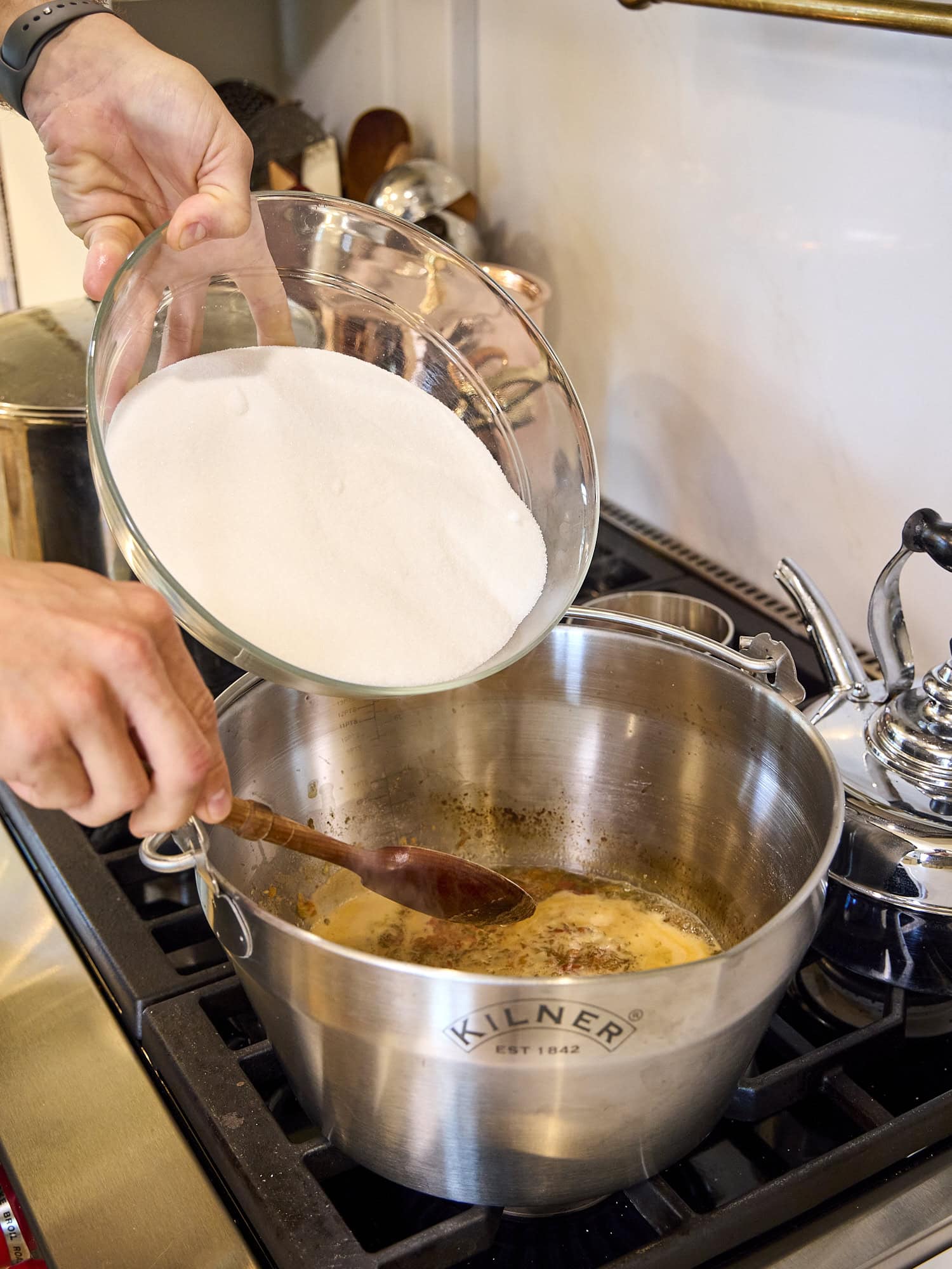 Sugar being added to hot pepper jelly cooking.