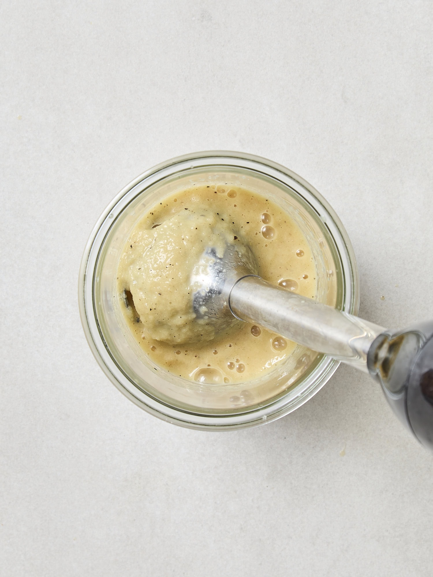 Apple cider vinaigrette being blended in a canister.