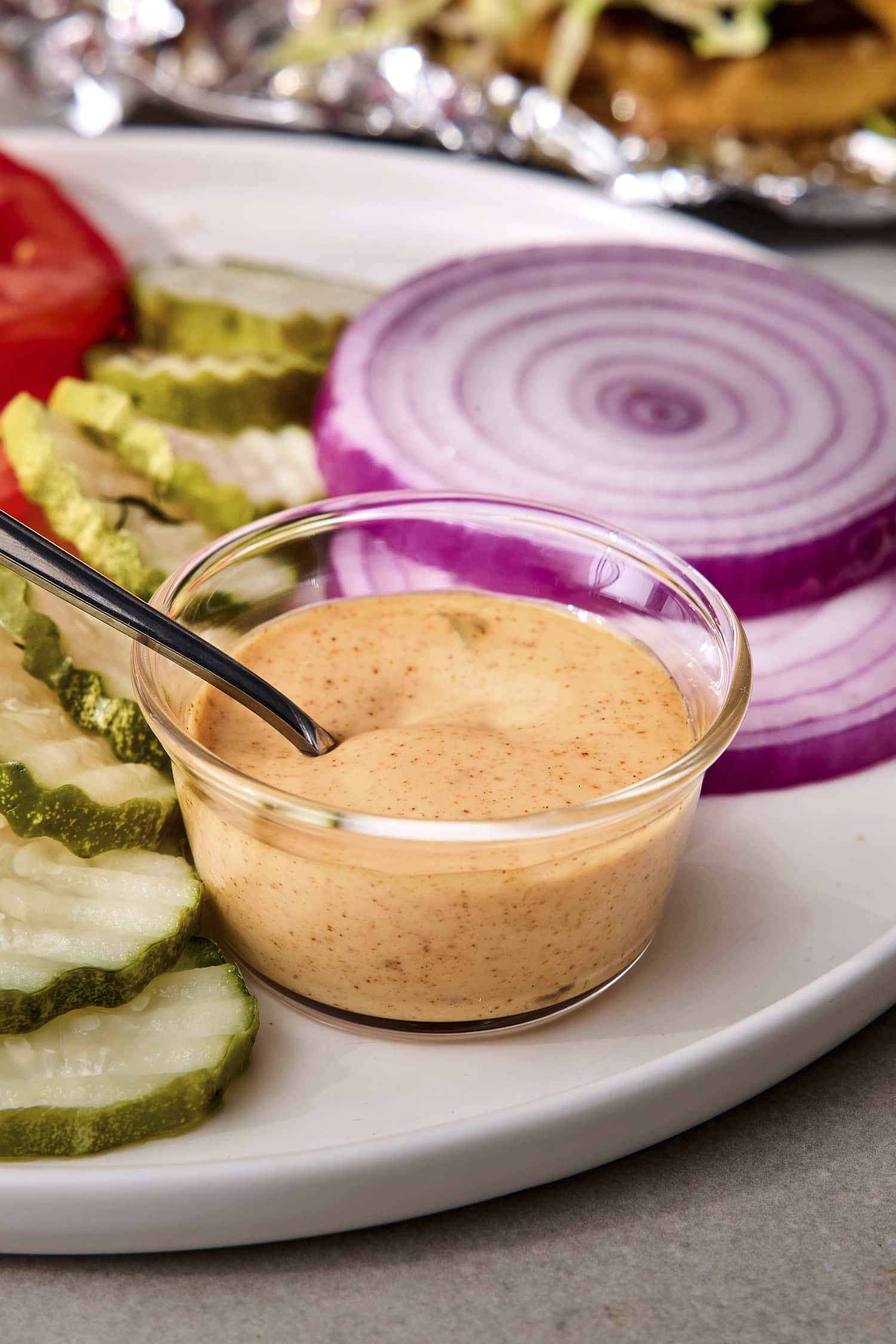 Small glass bowl with creamy easy burger sauce.