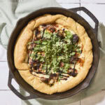 Cast iron skillet with fall pizza recipe baked inside.