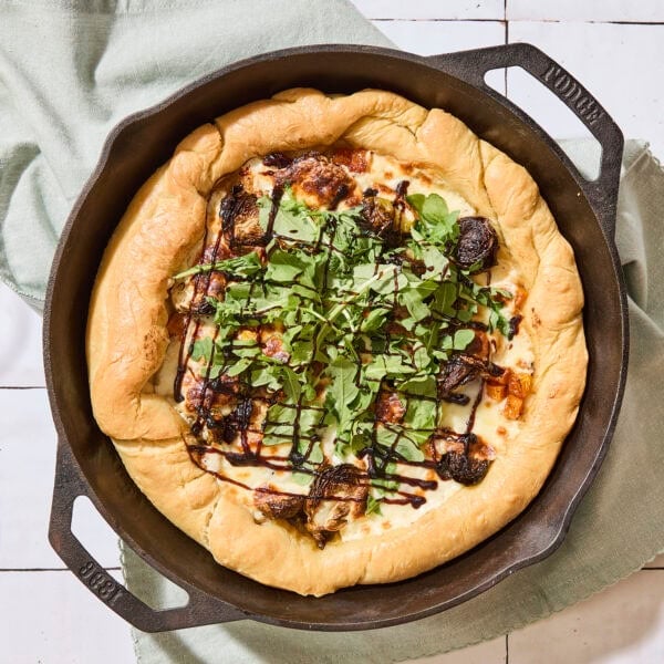 Cast iron skillet with fall pizza recipe baked inside.
