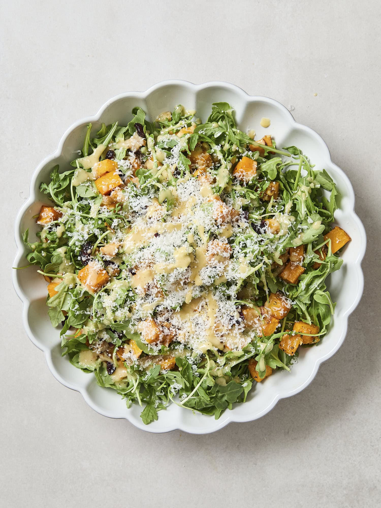 Butternut squash salad with Parmesan cheese on top.
