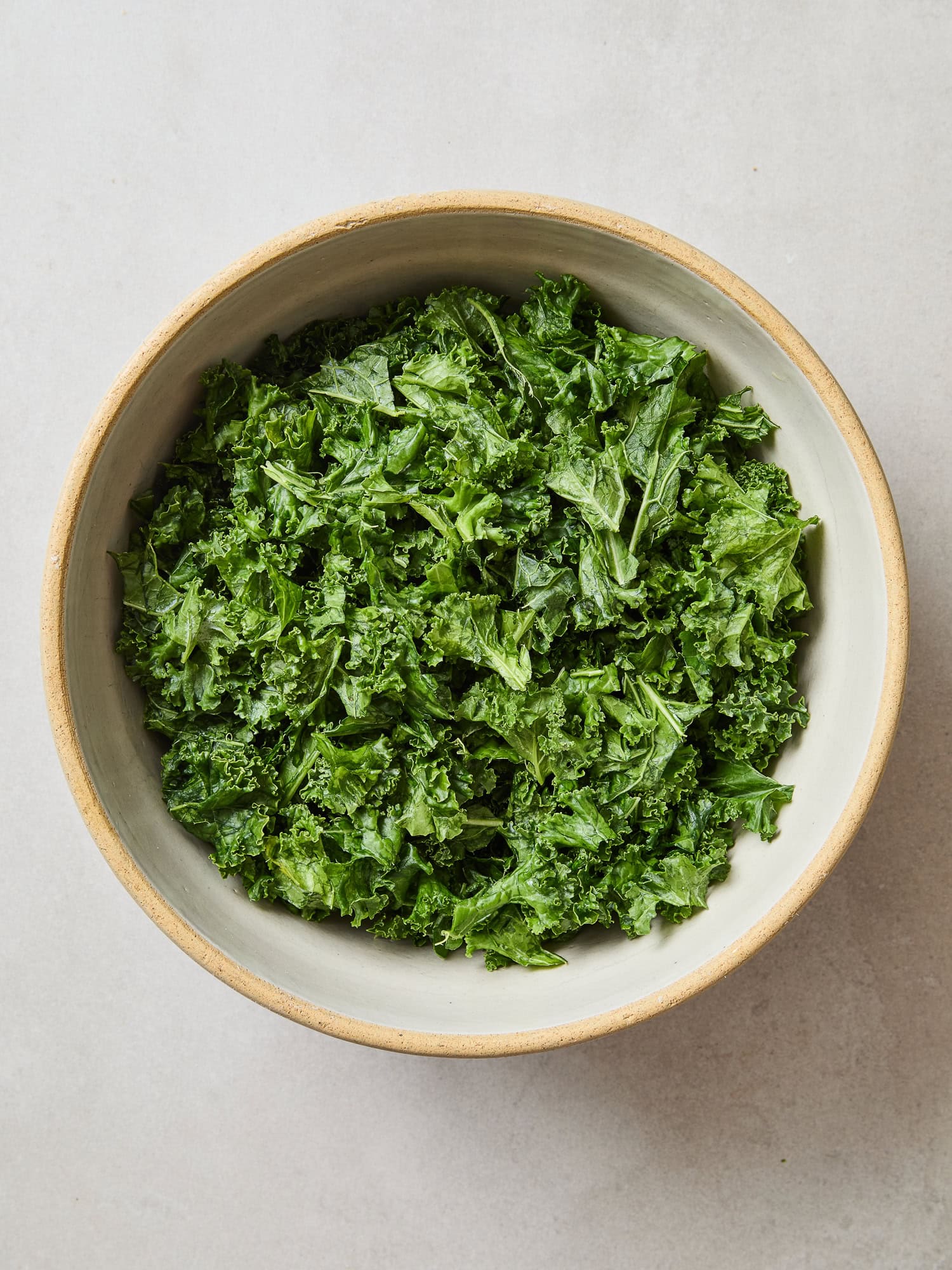 Washed kale drying in a bowl.