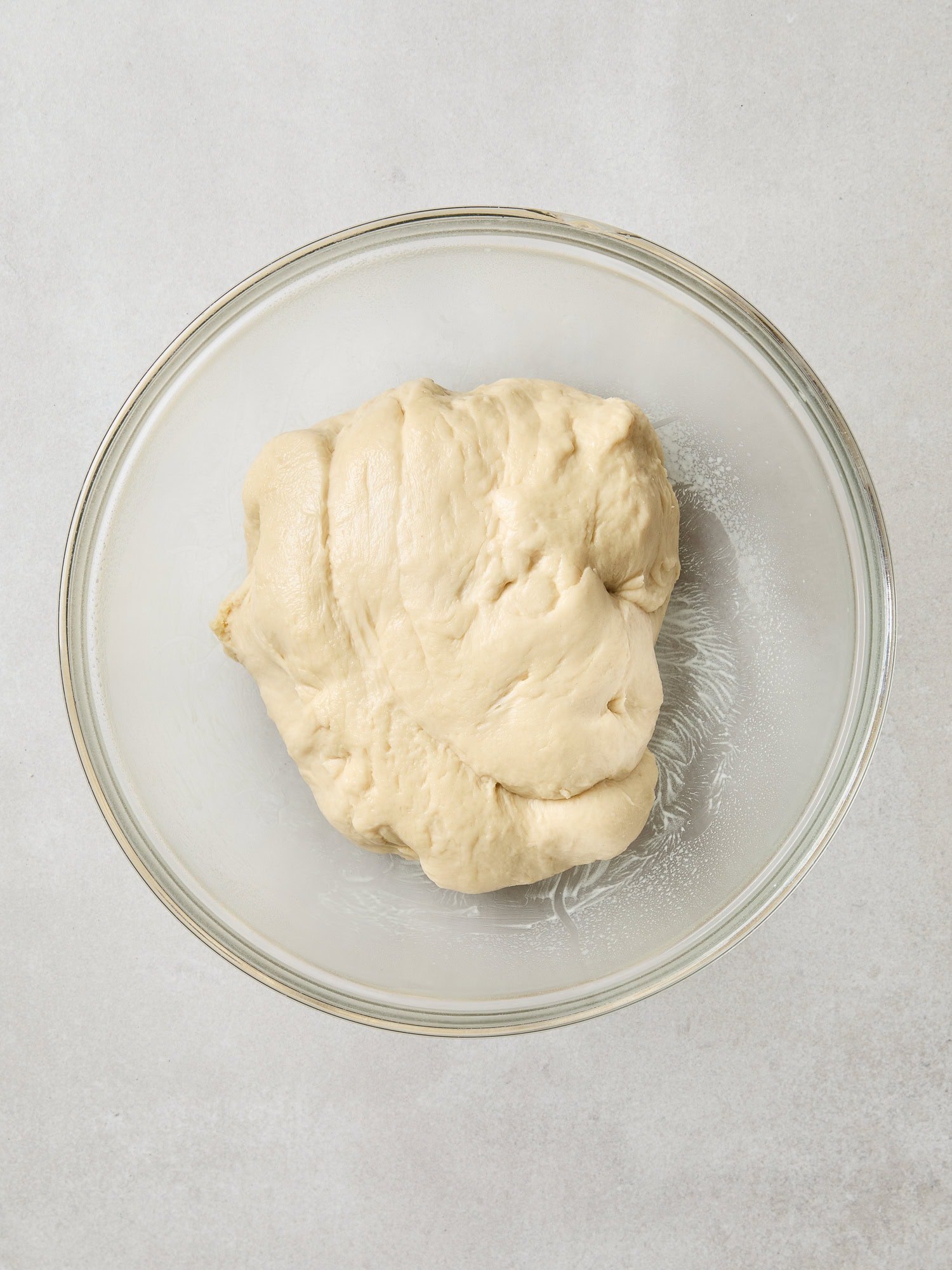 Cinnamon roll dough in an oiled bowl prior to rising.