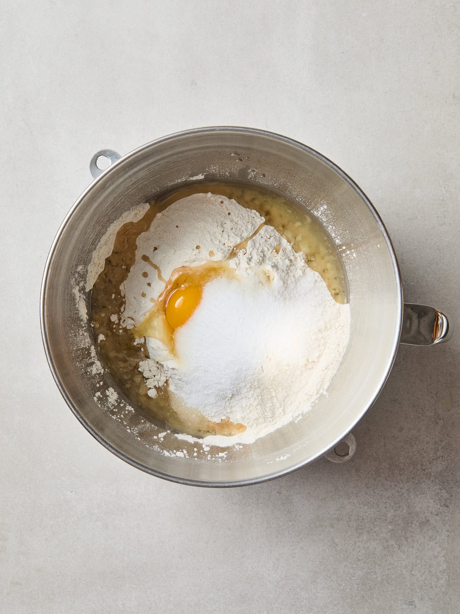Ingredients for cinnamon roll dough in a stand bowl mixer.