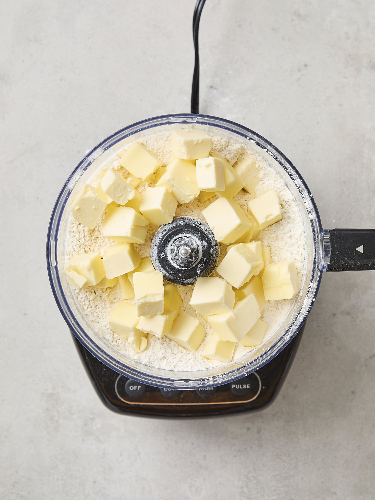 Pieces of butter in a food processor.