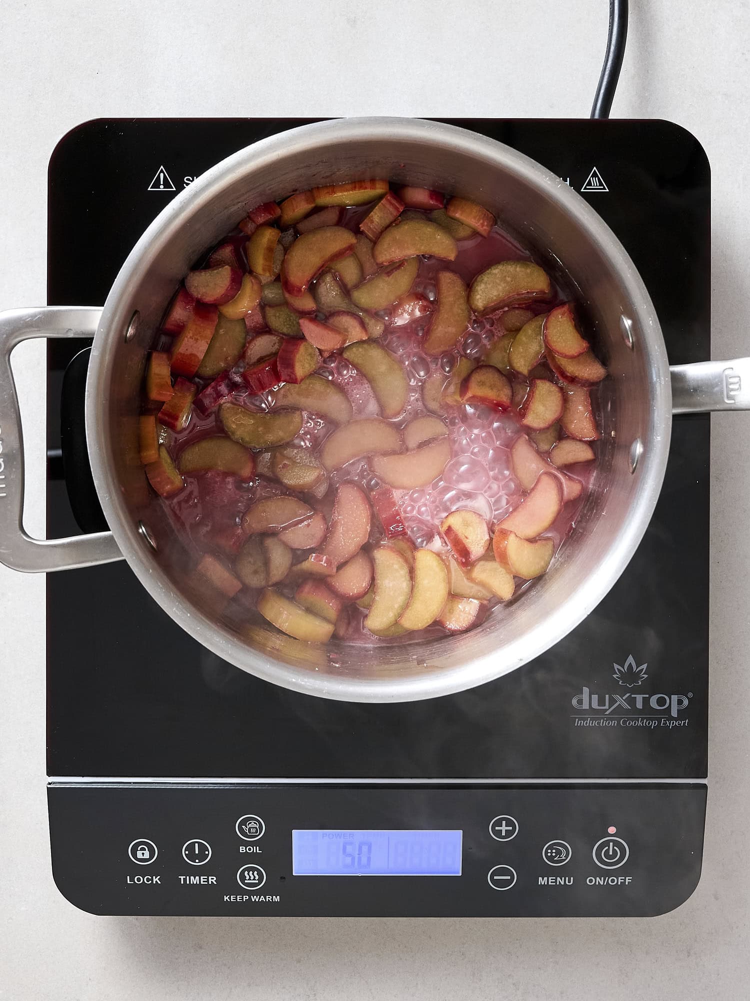 Cooking rhubarb in a saucepan.