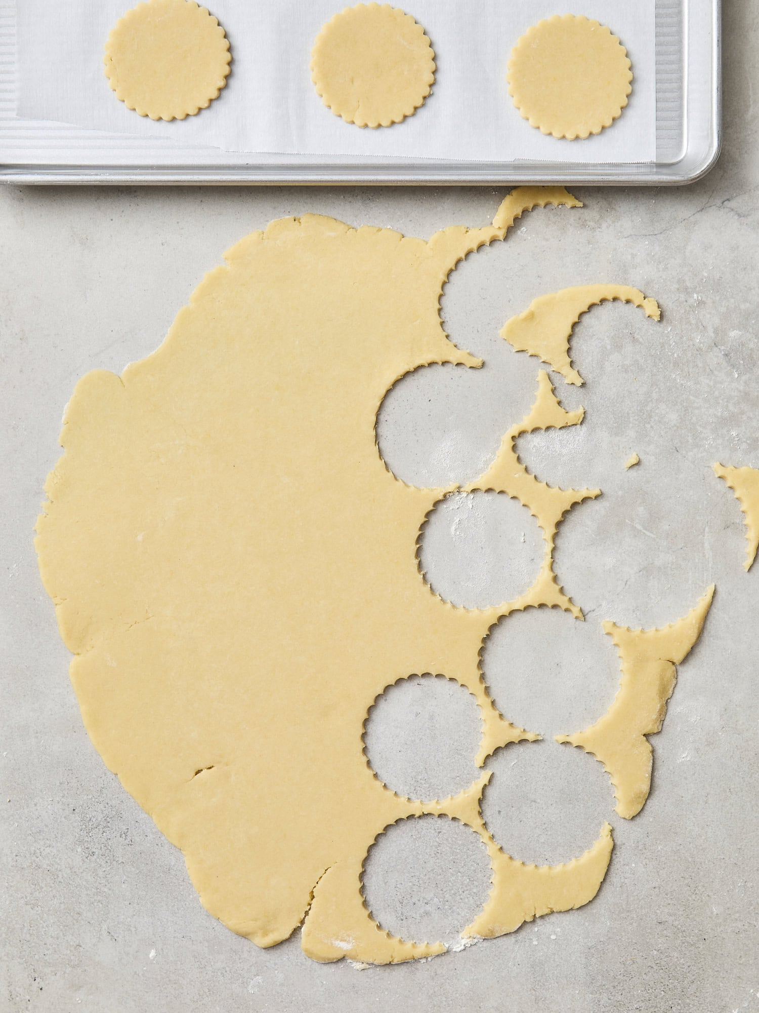 Circles cut out of rolled out dough and placed on baking sheet.