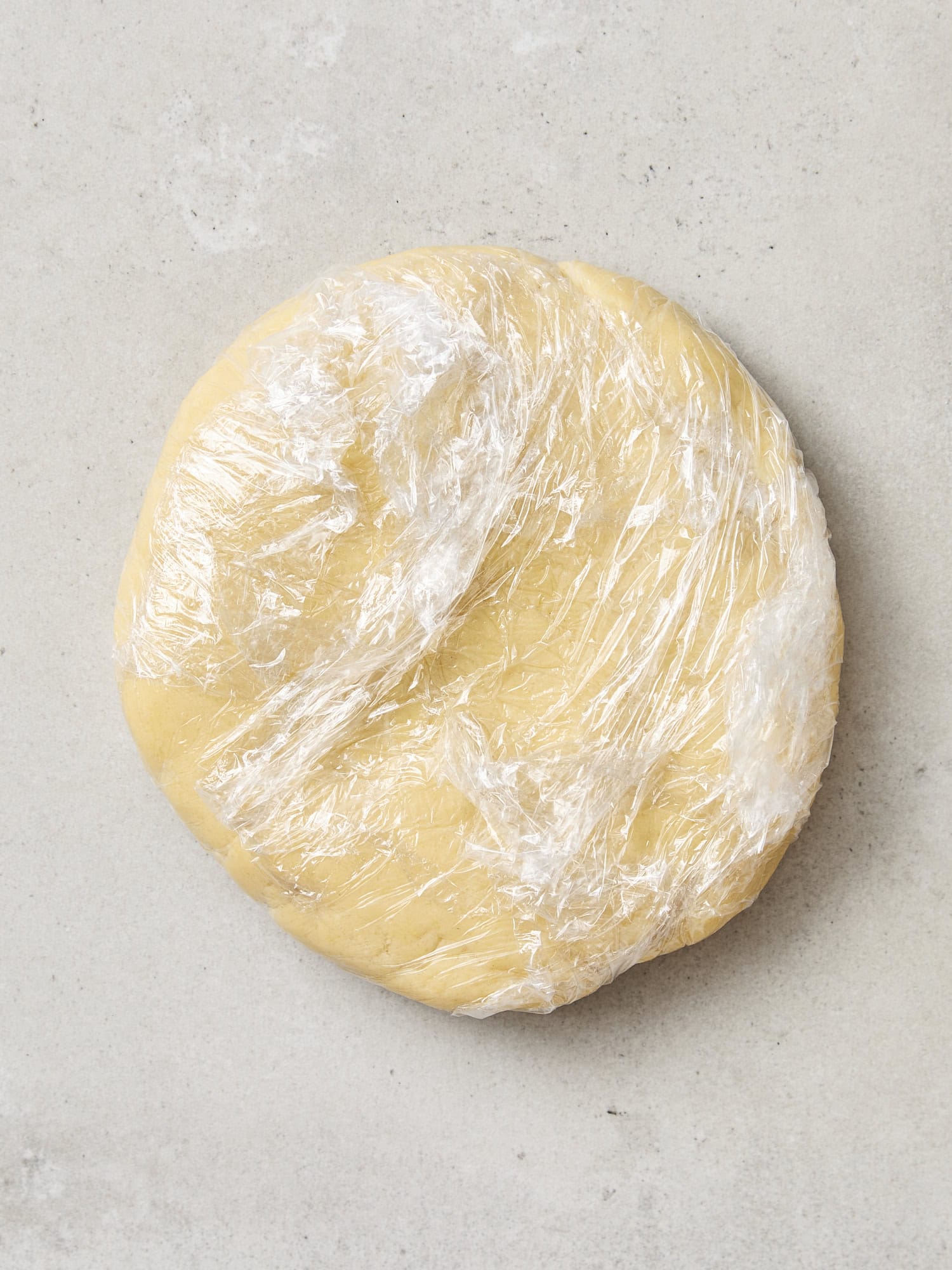 Rolled up cookie dough wrapped in parchment.