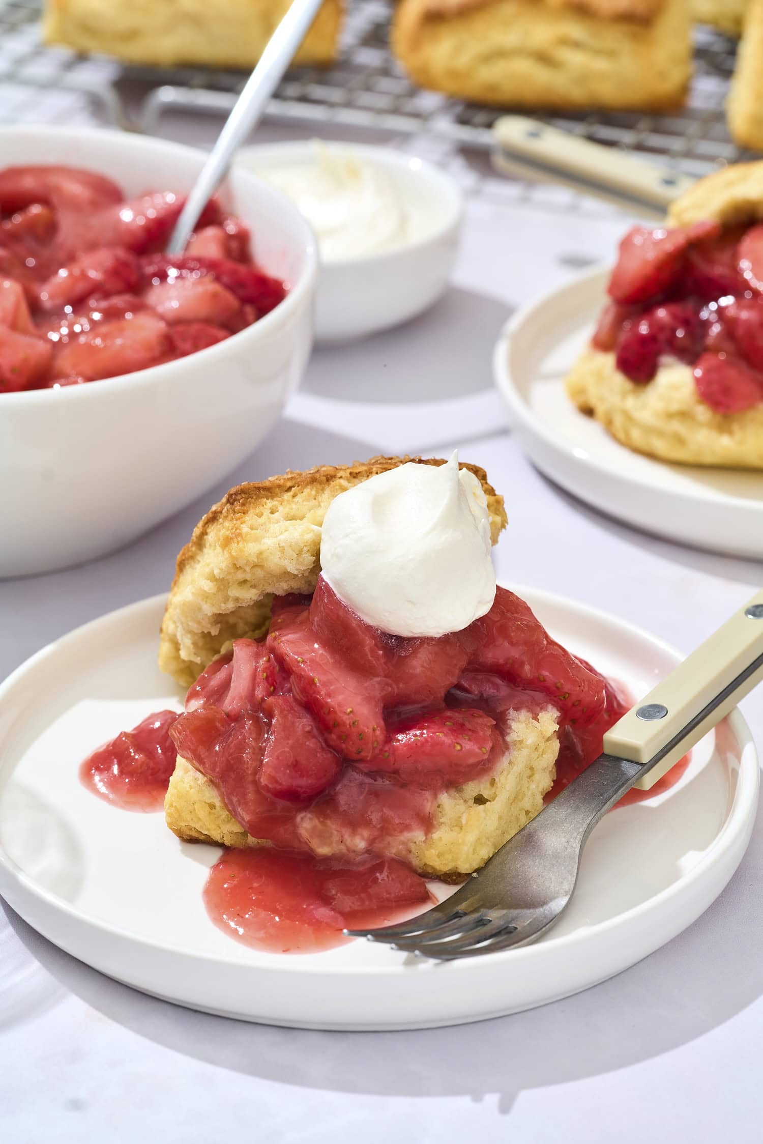 Two biscuits with strawberry rhubarb filling and whipped cream.