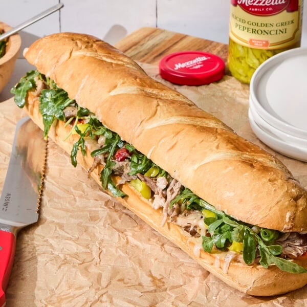 Italian pork sandwich assembled and ready to be sliced.