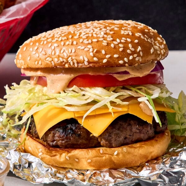 Grilled burger recipe in bun with toppings.