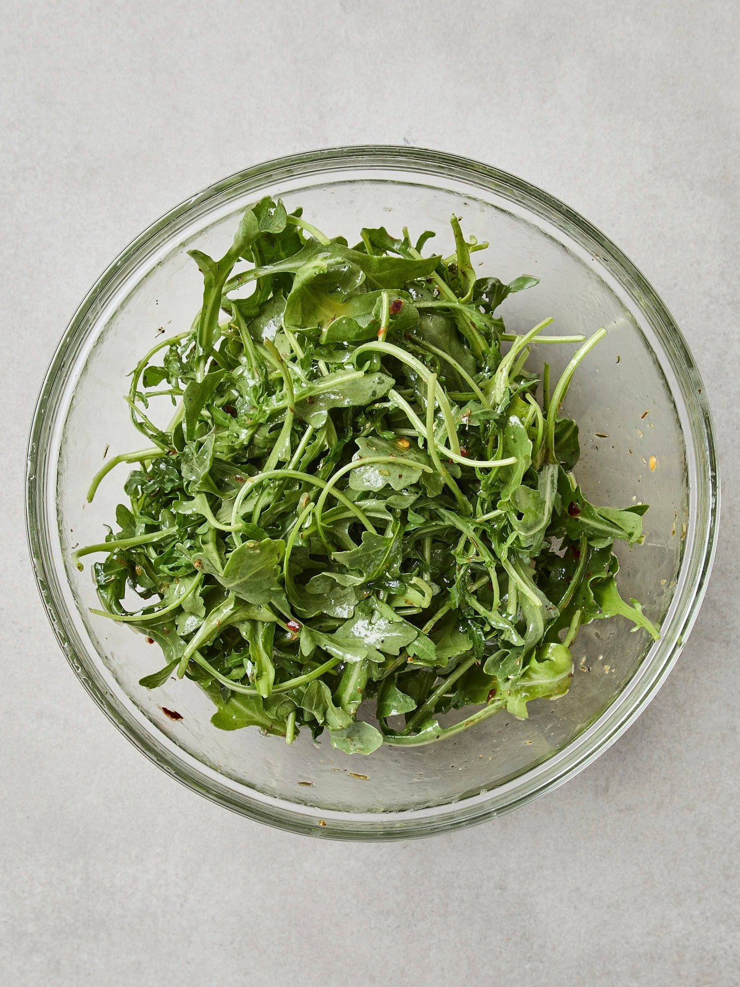 Greens tossed with a salad dressing.