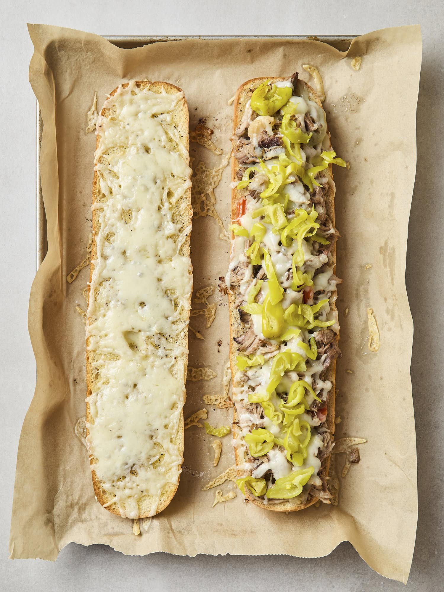 Pepperoncini layered on top of melted cheese on sandwich.