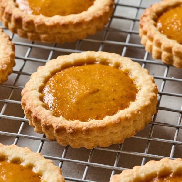 Baked mini pumpkin pie cookie on baking rack.