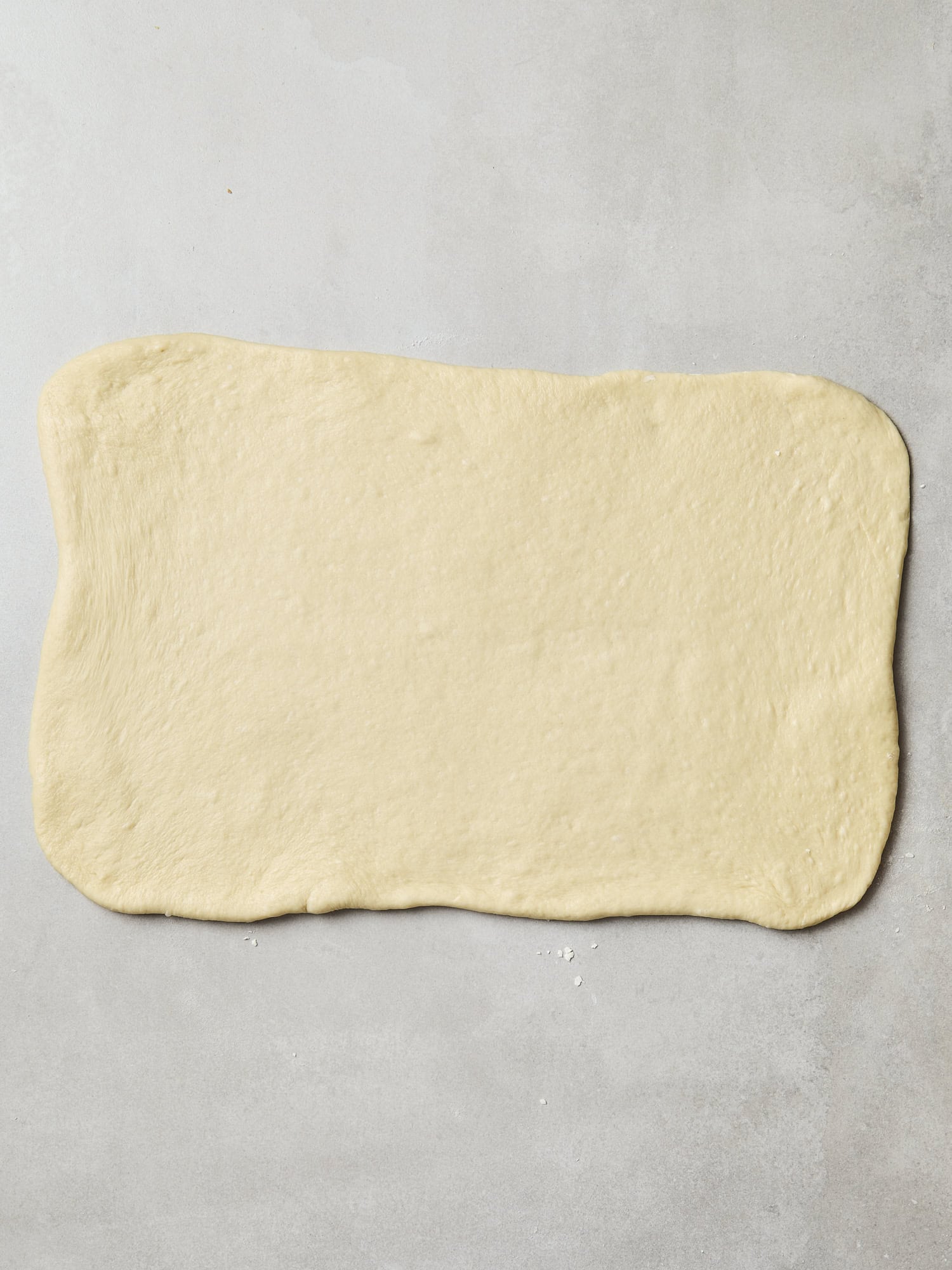 Dough rolled out into a flat rectangle to create cinnamon rolls.