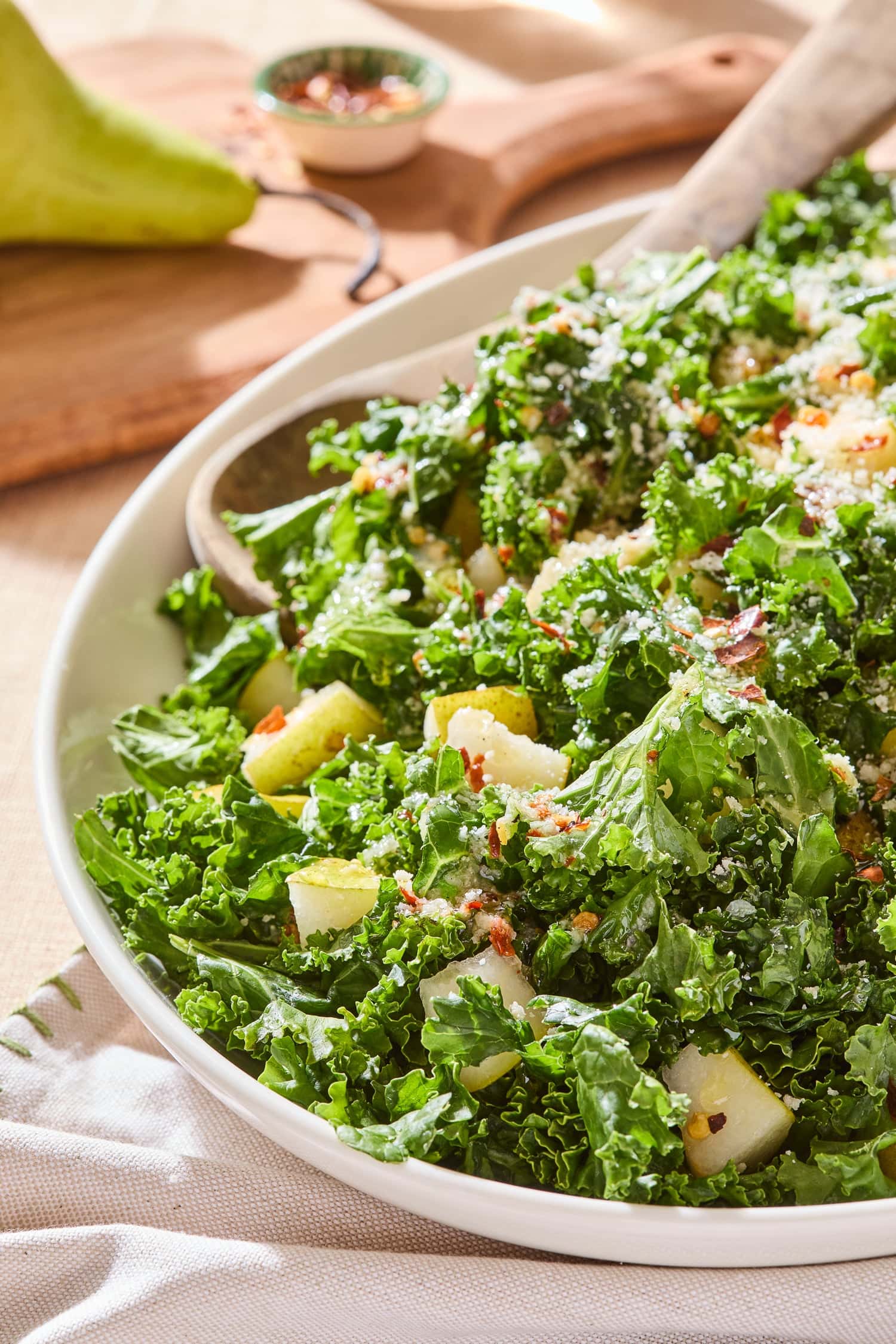 Spicy pear kale salad topped with shredded parmesan.
