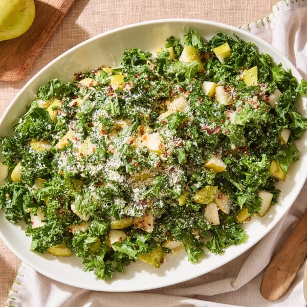 A serving platter with spicy pear kale salad.