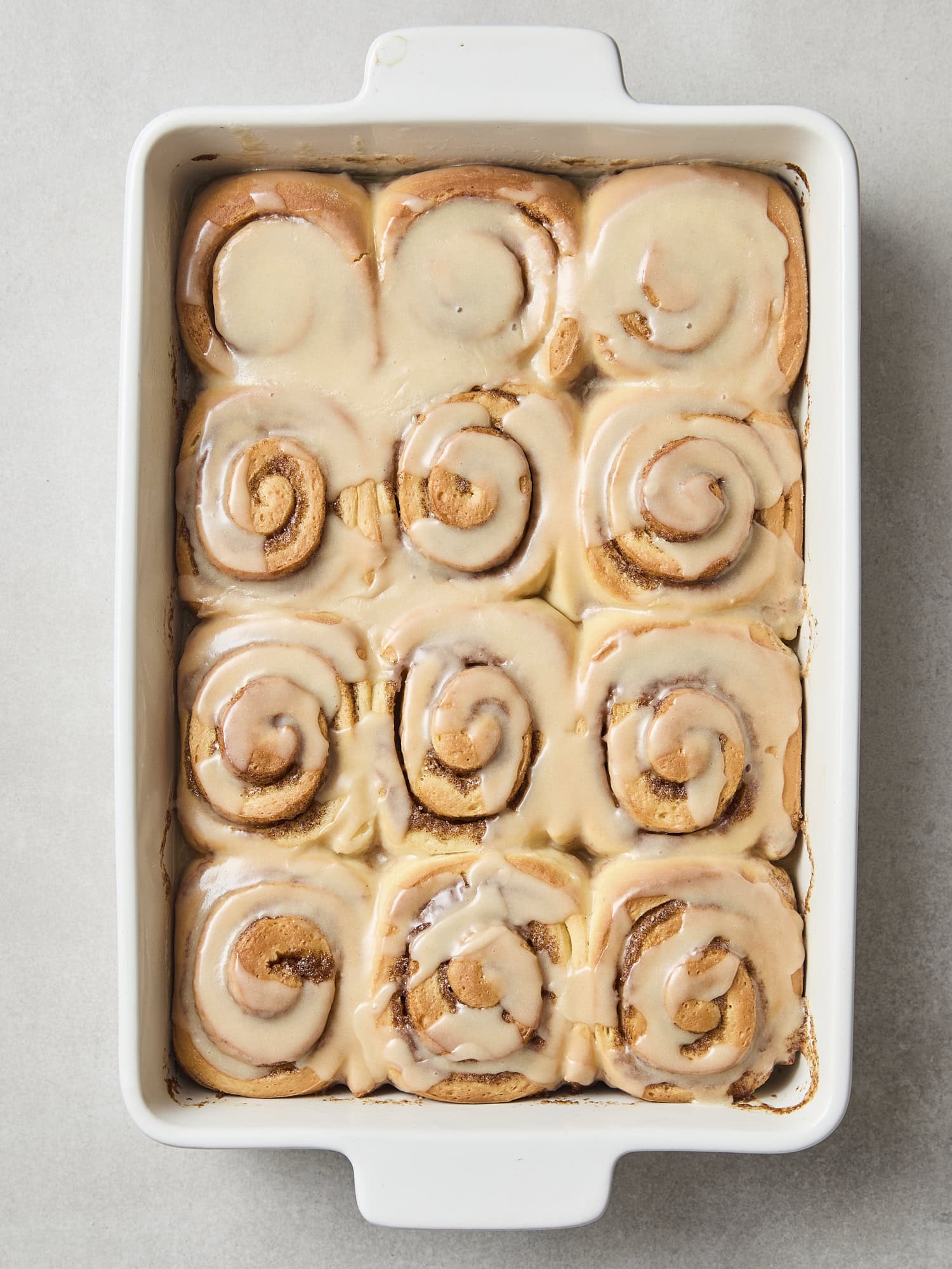 Baked cinnamon rolls topped with a brown butter frosting.