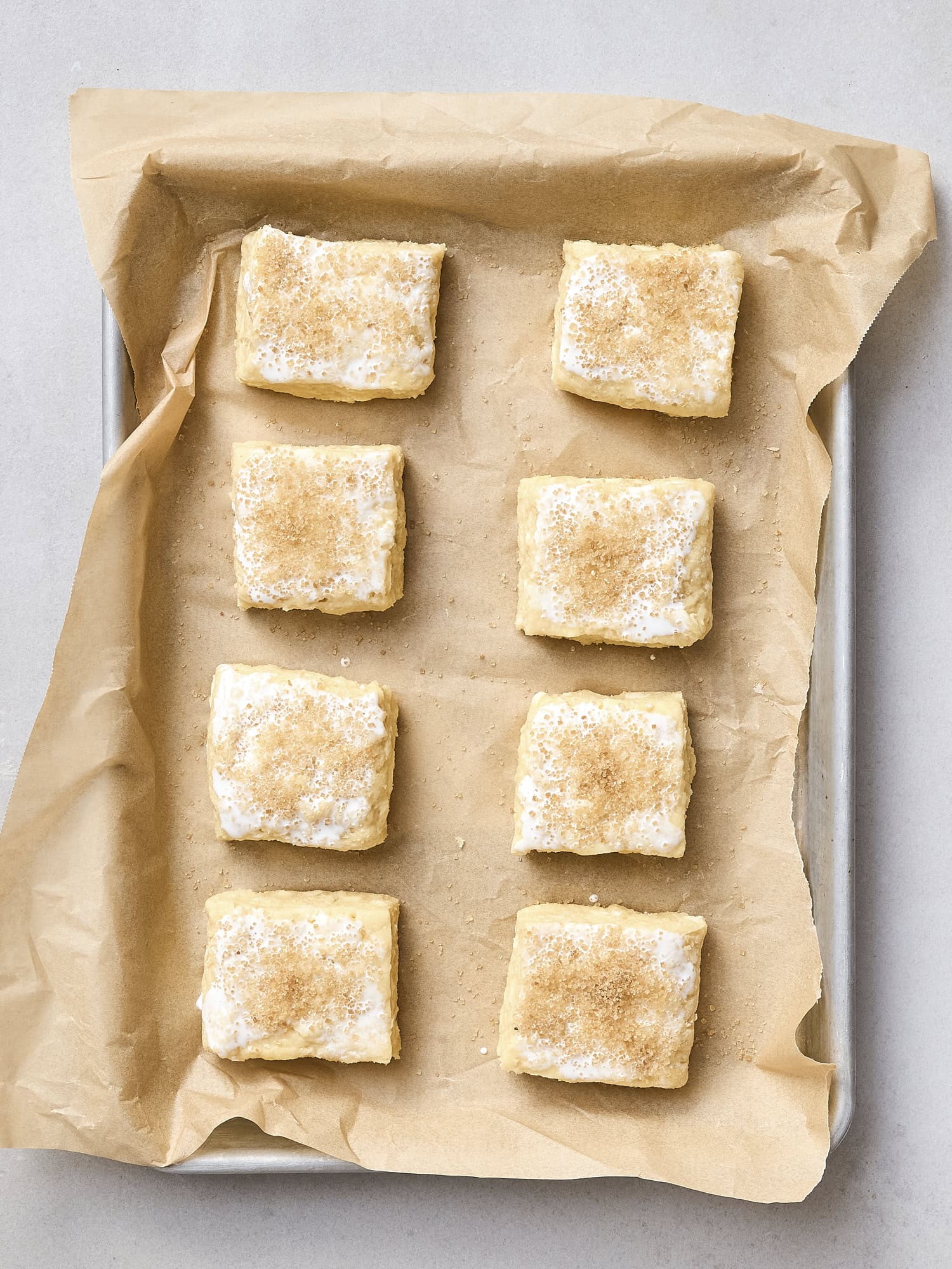 Unbaked biscuits on baking sheet.