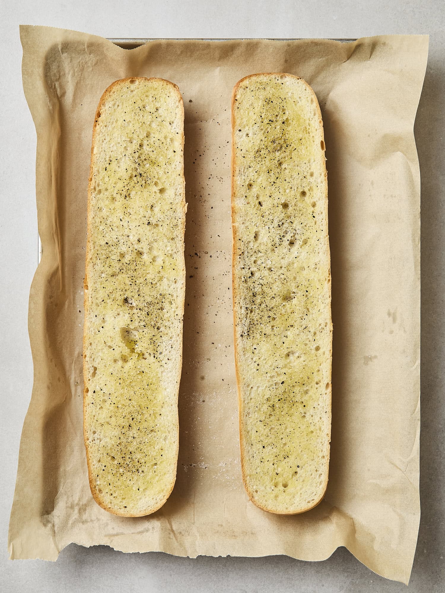 Two slices of French bread after being toasted.