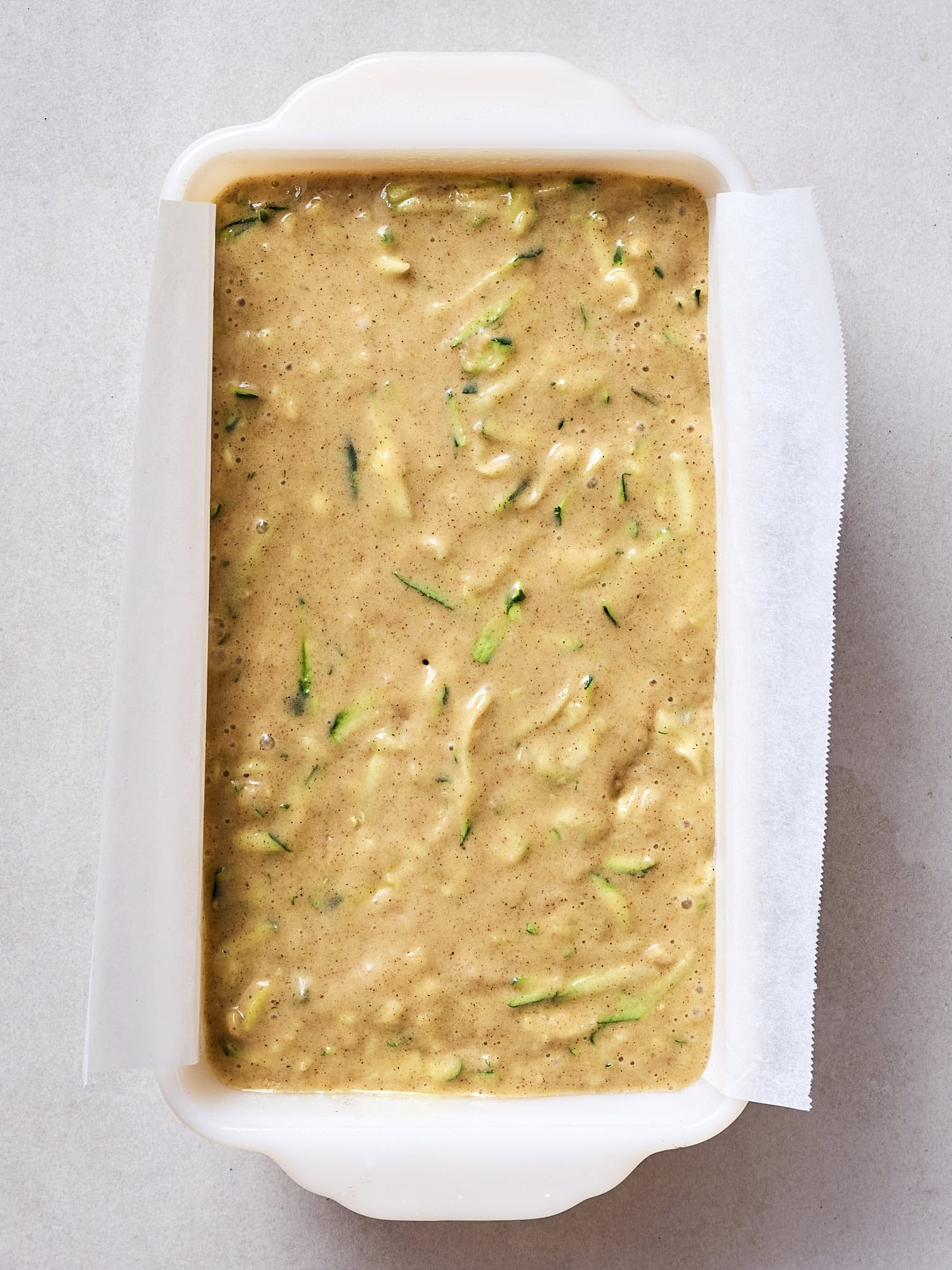 Batter poured into loaf pan for zucchini bread.