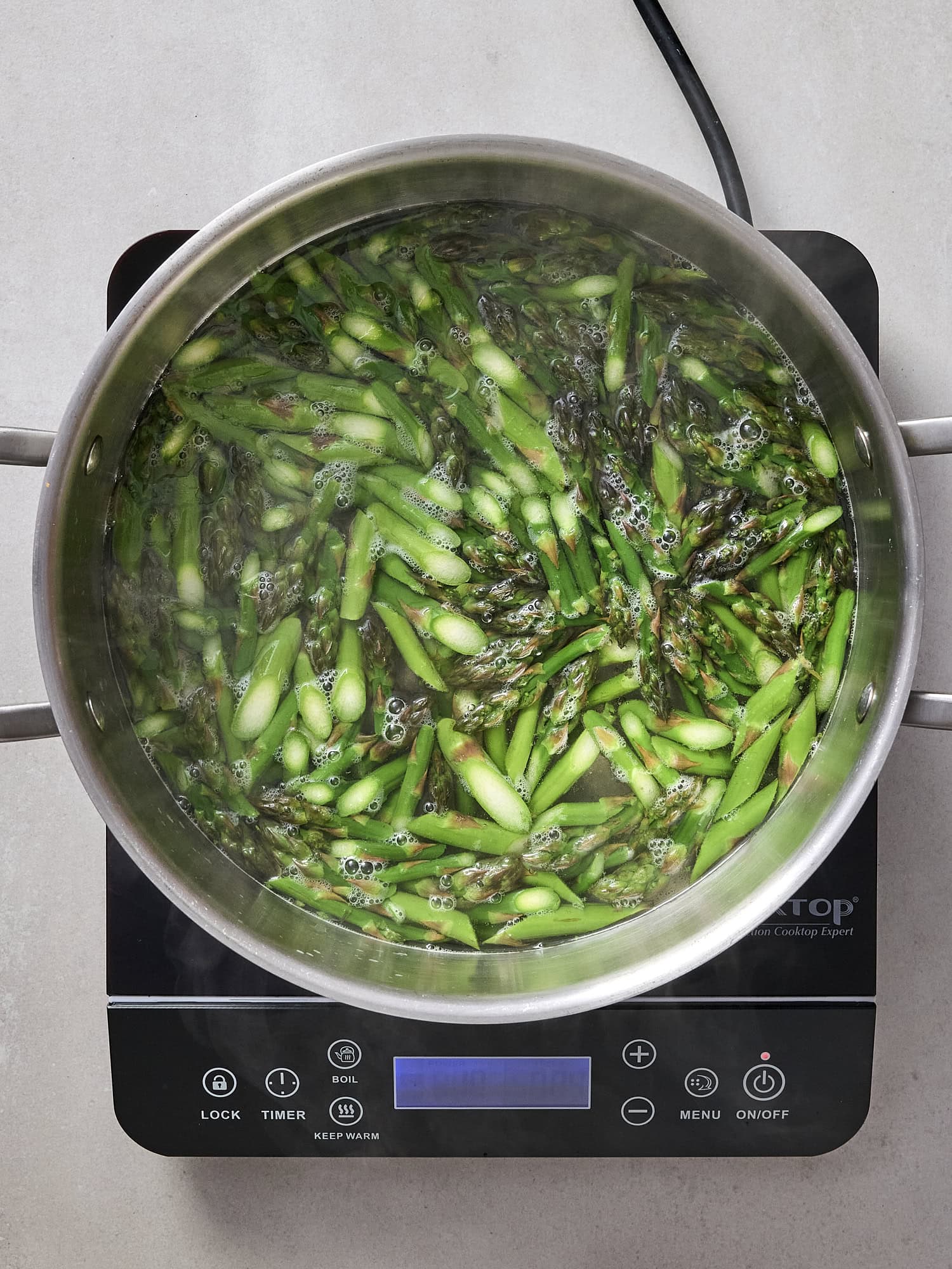 Blanching asparagus for salad.