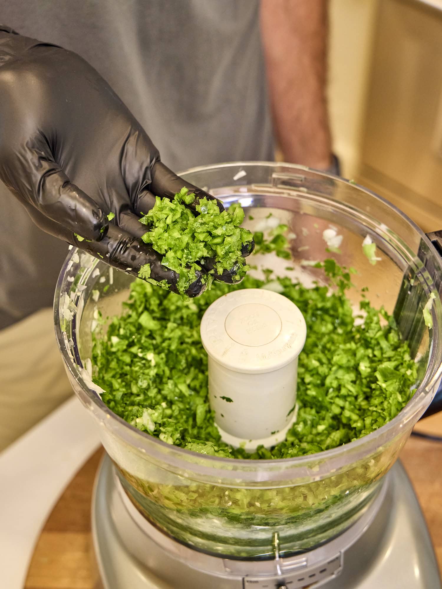 Chopped jalapeño in a food processor.