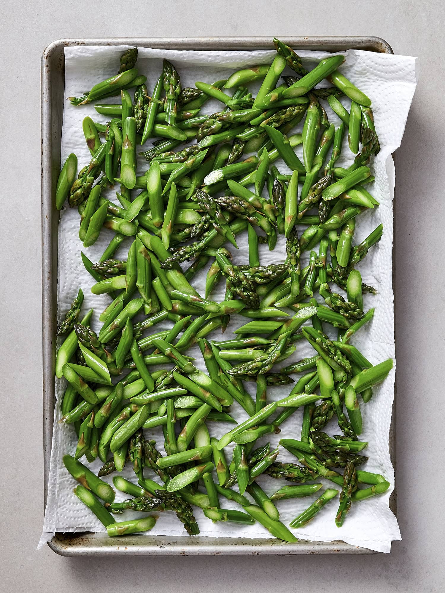 Drying blanched asparagus on sheet pan.